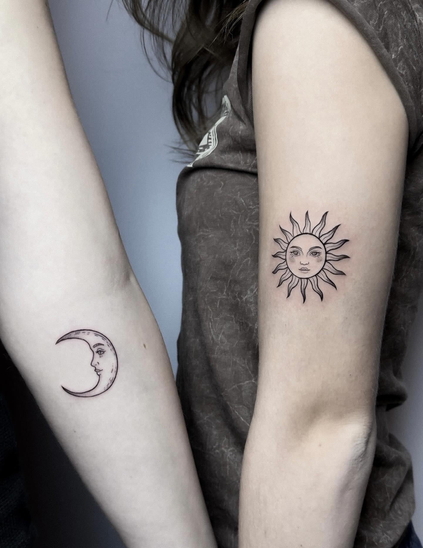 Sun and moon black and grey tattoo on the forearm by Whimsical Tattoos