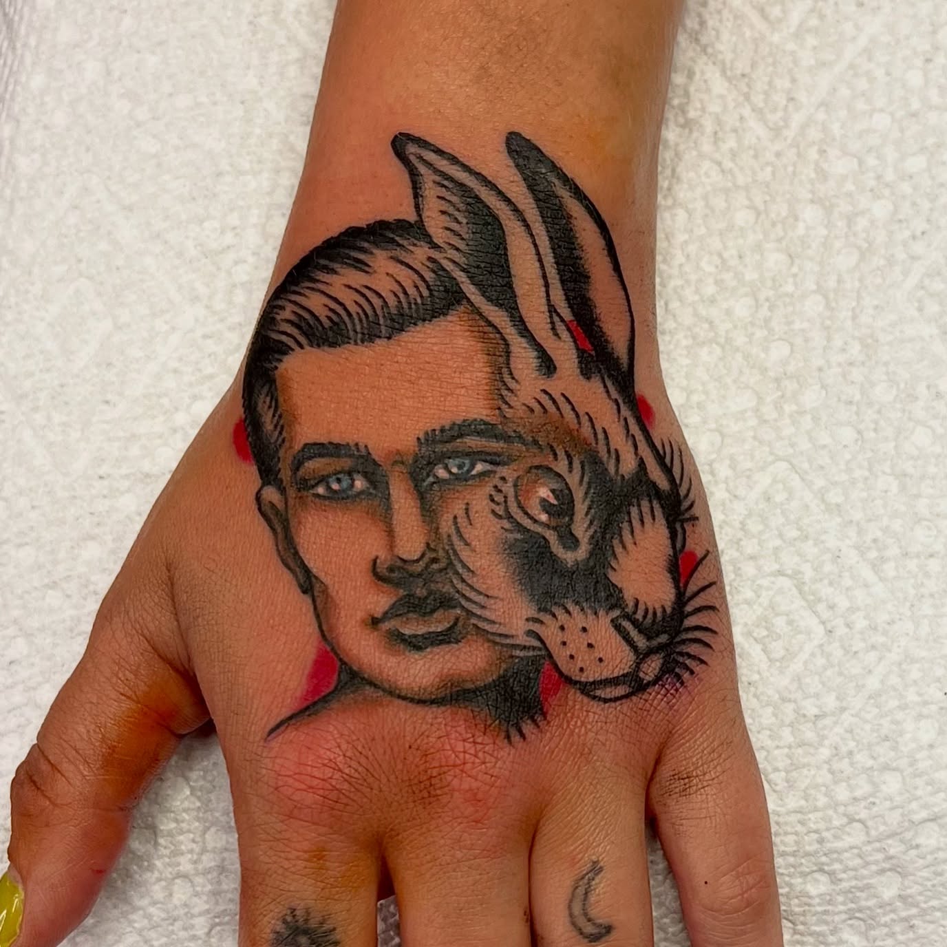 Man and rabbit American traditional tattoo on the hand by @brandonhuckabey, Denver, Colorado