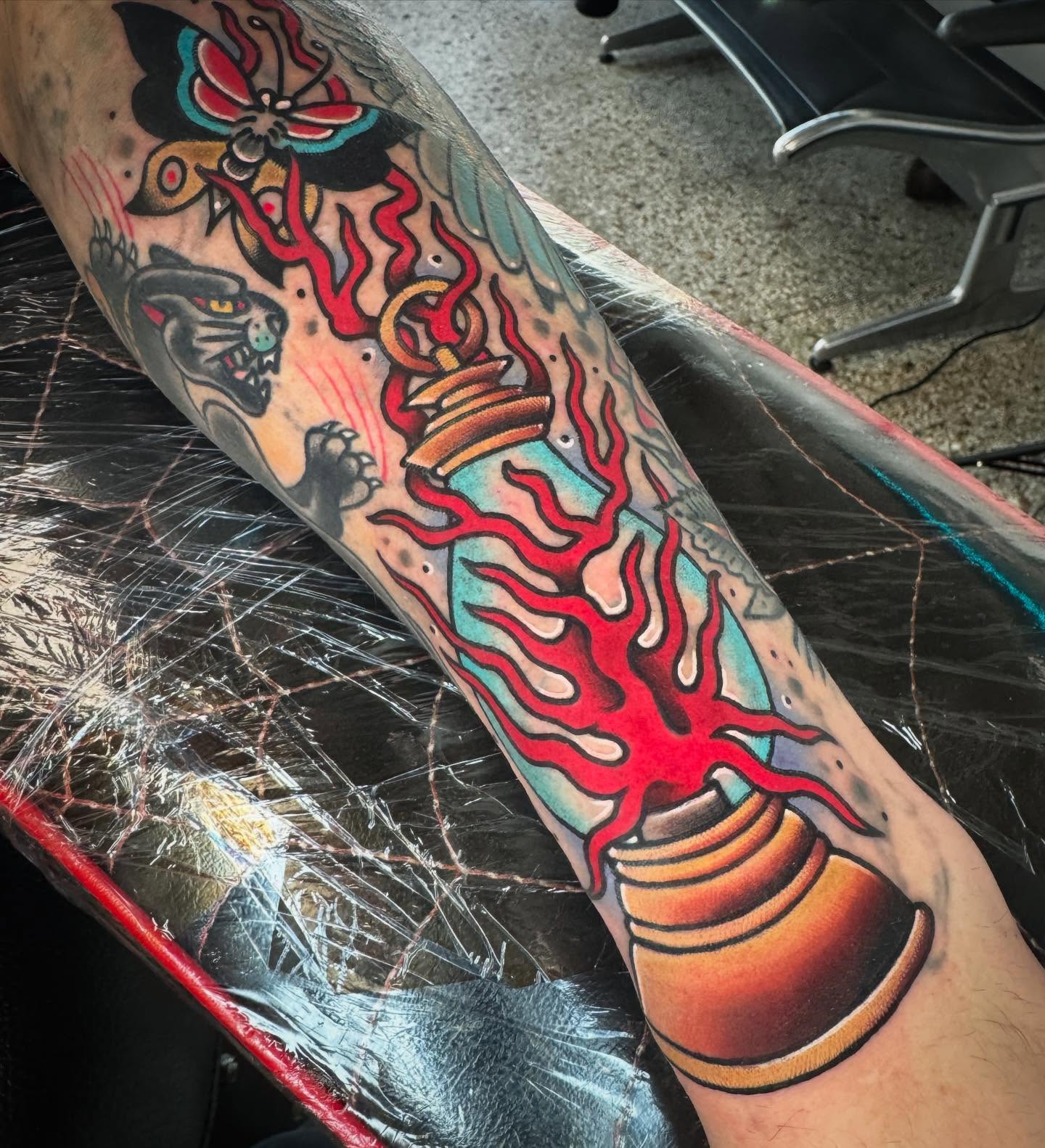 Flame and bell American traditional tattoo on the forearm by Graham Edward Vogel