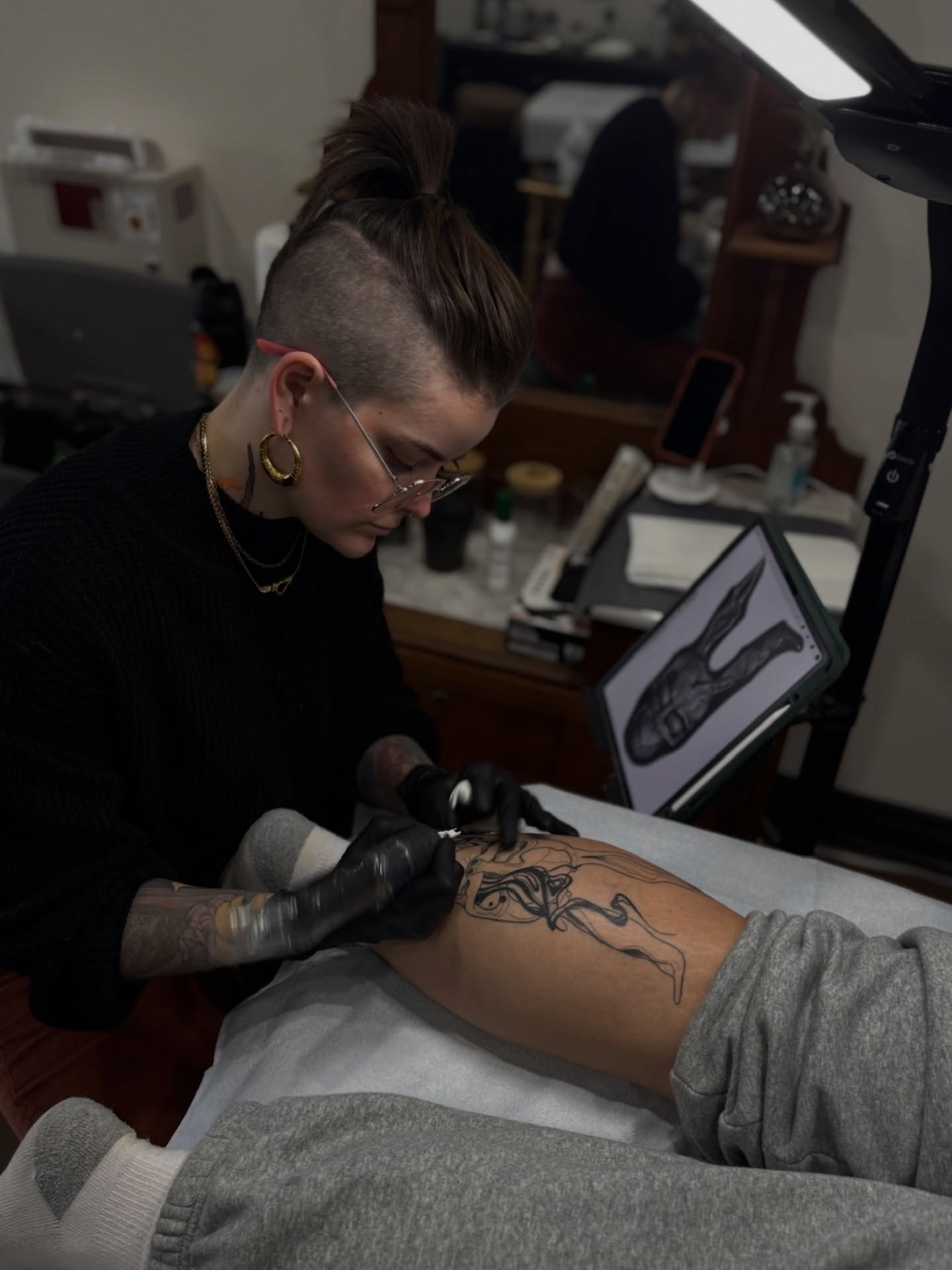 Woman black and grey tattoo on the thigh by Alyssa Shirkey