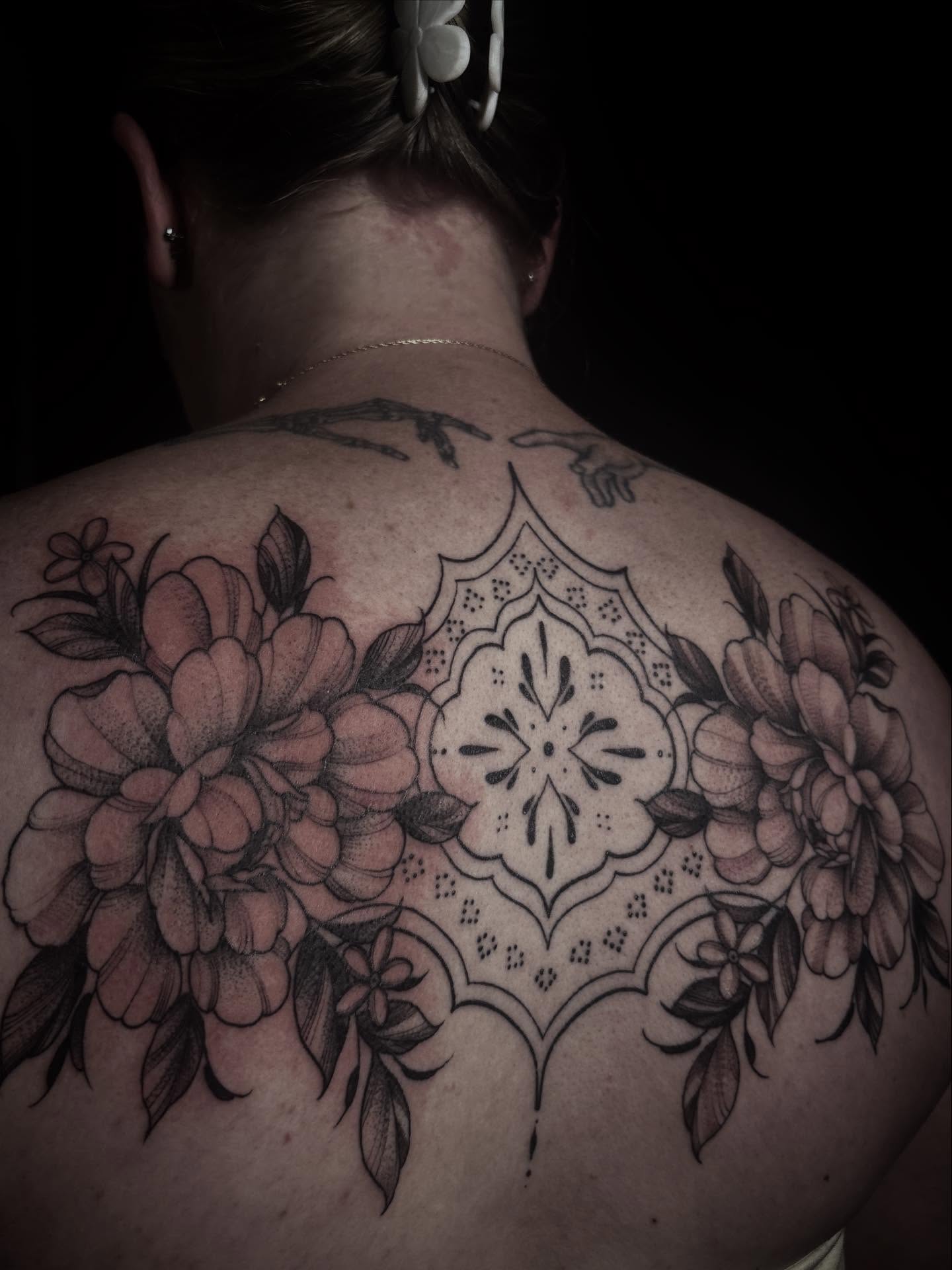Floral mandala ornamental tattoo on the back by Lena Lawrence