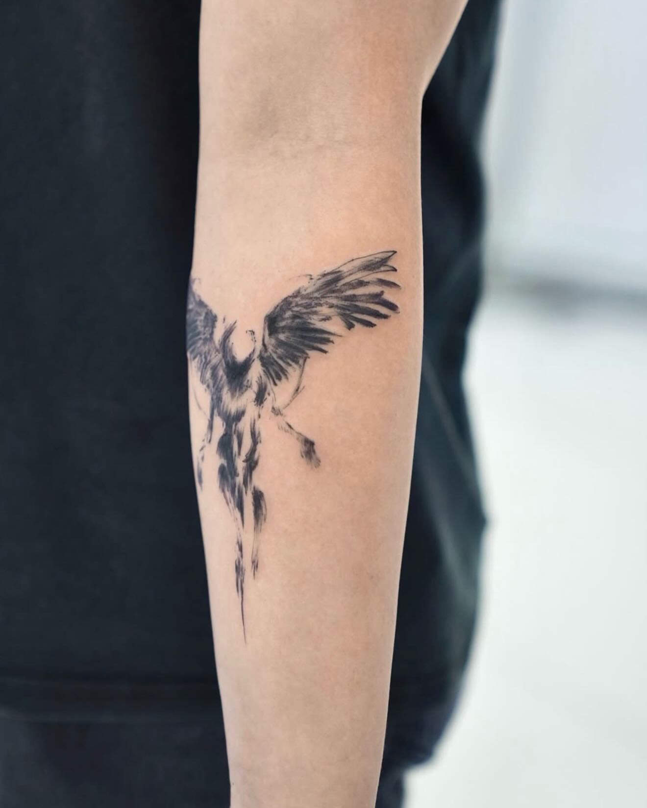 Phoenix black and grey tattoo on the forearm by MJ tattooist