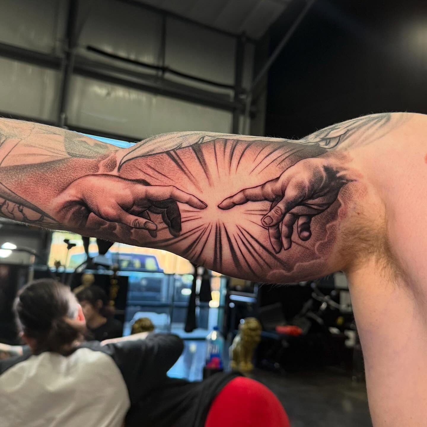Creation scene realism tattoo on the forearm by Carlos Lujan