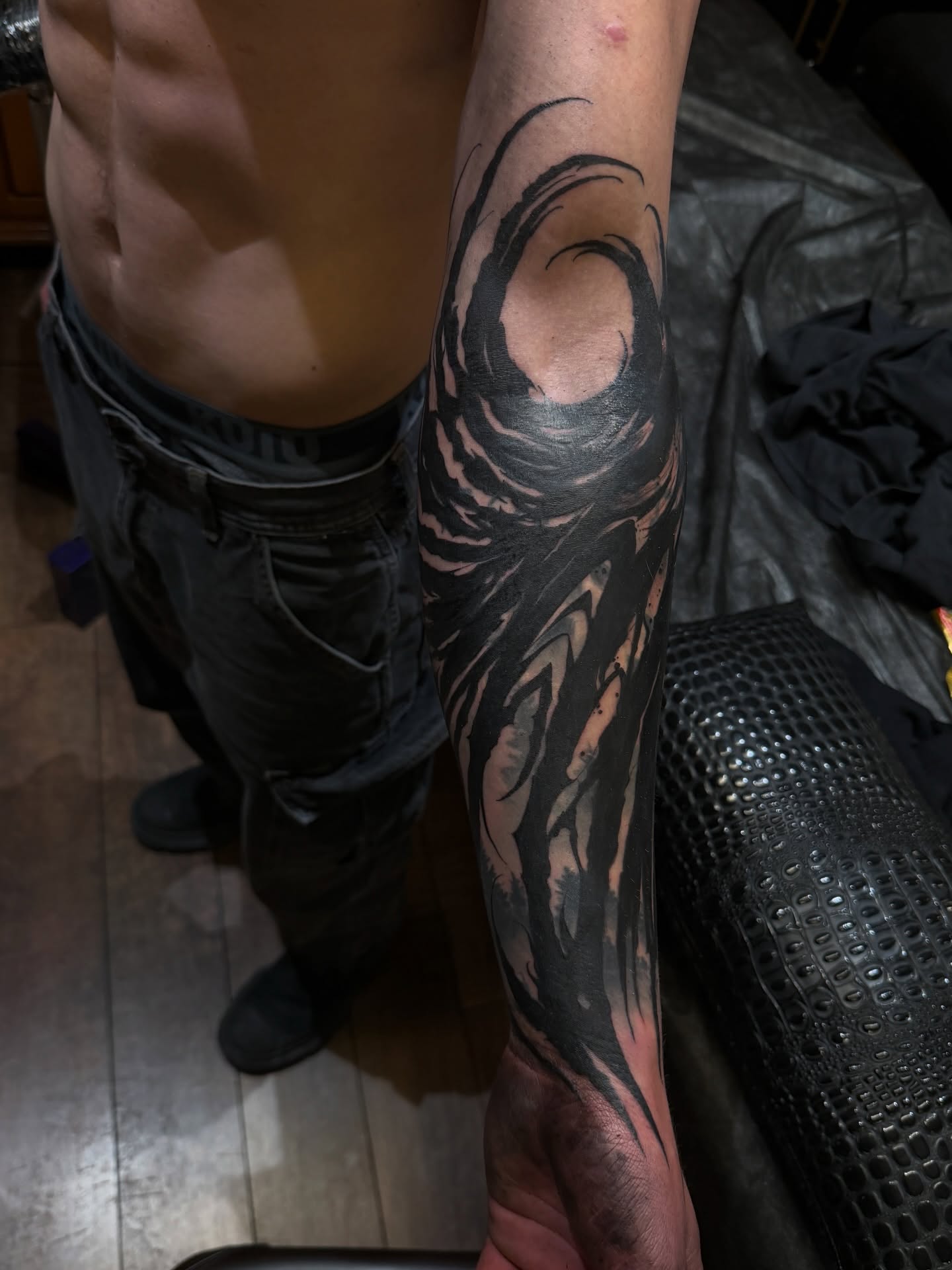 Abstract swirl black and grey tattoo on the forearm by Denver Blackout Tattoo Specialist - Anthony