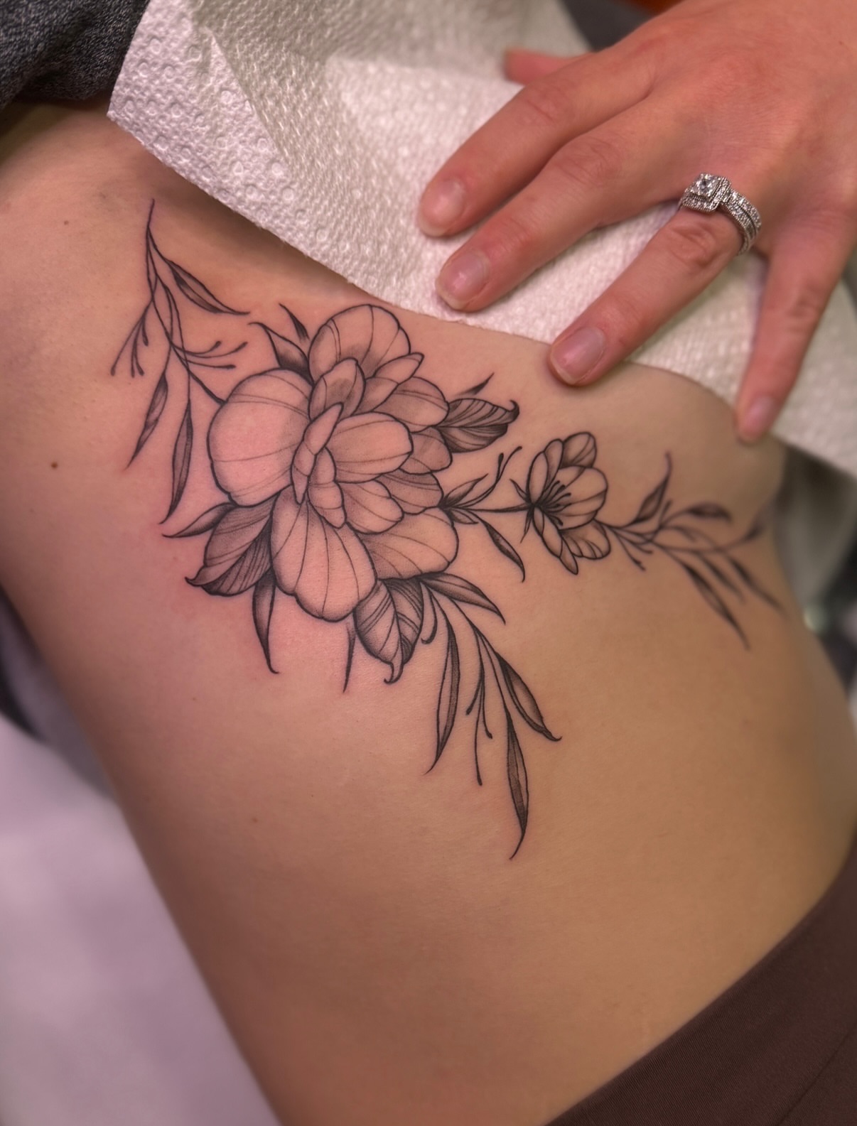 Floral bouquet black and grey tattoo on the thigh by Ethan, Toledo, Ohio