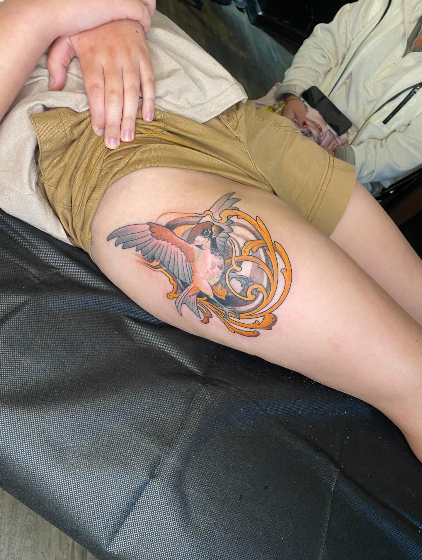 Bird and floral ornament American traditional tattoo on the thigh by Kyle Kozek, Columbus, Ohio