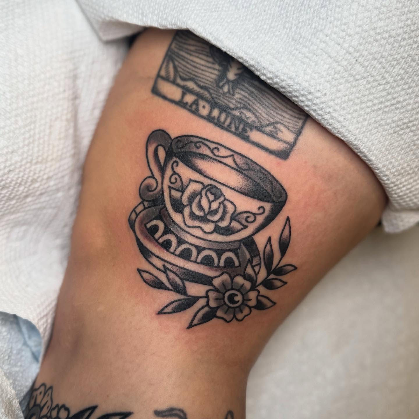 Teacup and rose American traditional tattoo on the forearm by Elle Yax