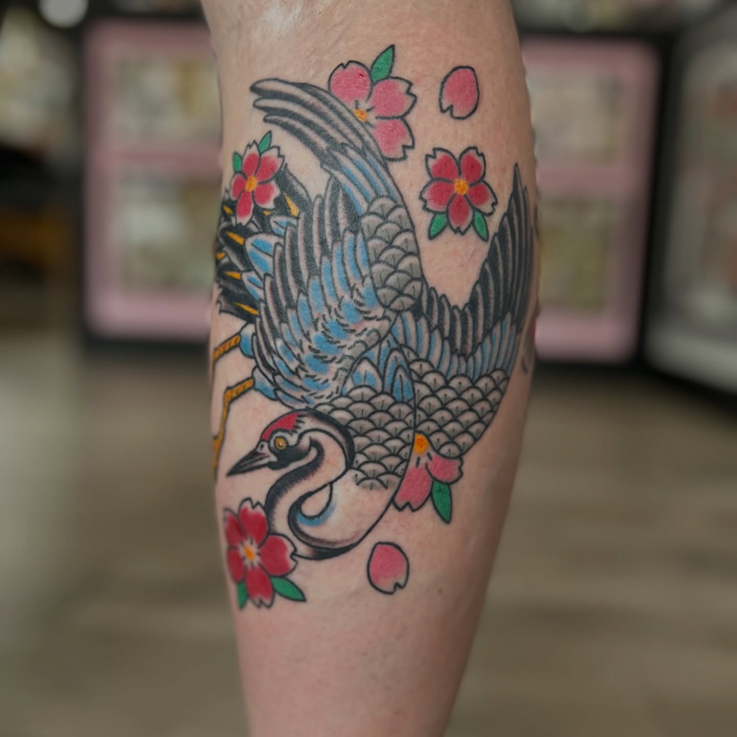 Crane and cherry blossoms American traditional tattoo on the forearm by Alex Fannin