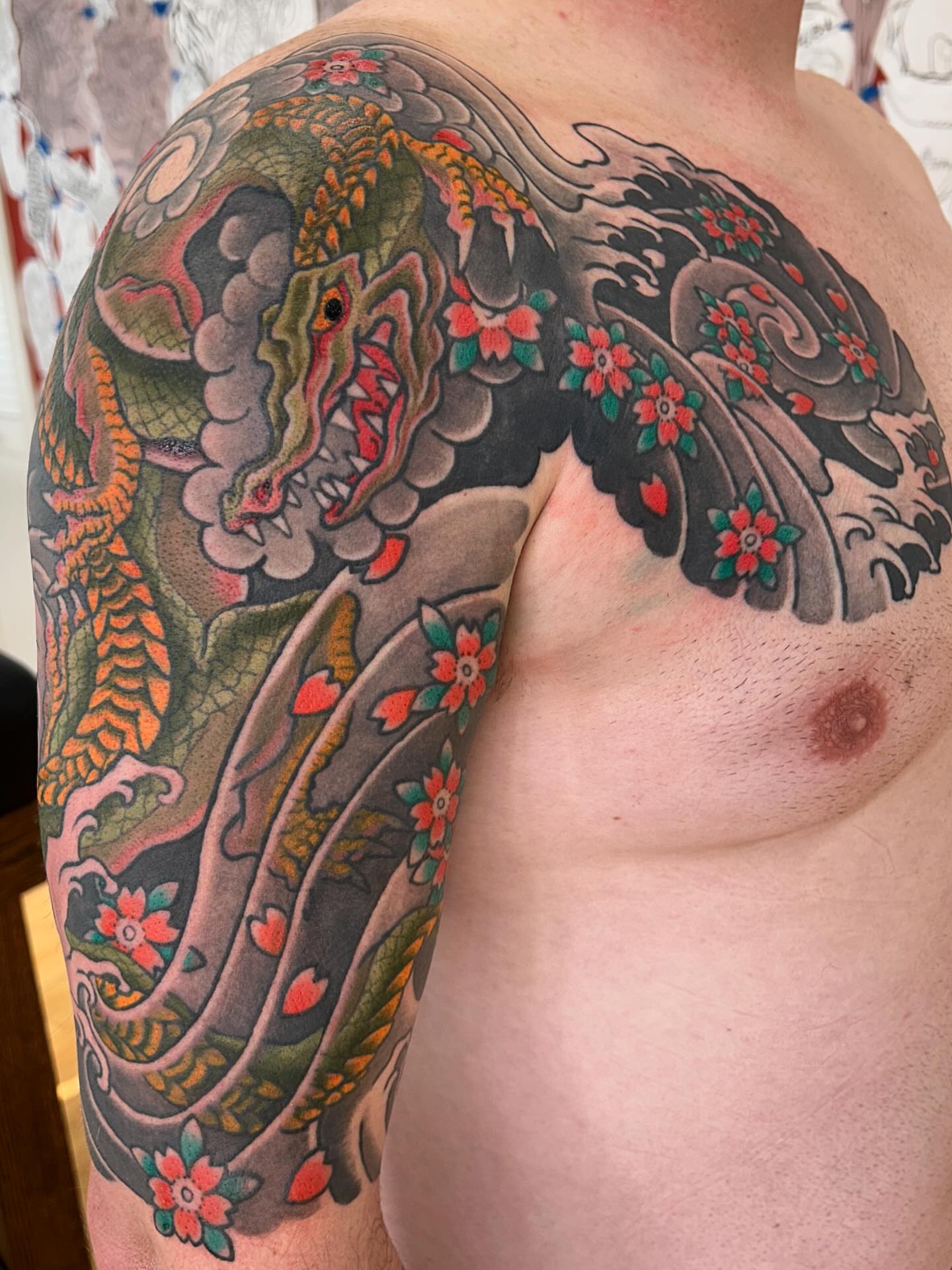 Dragon and flowers japanese irezumi tattoo on the shoulder by Matthew Crimson