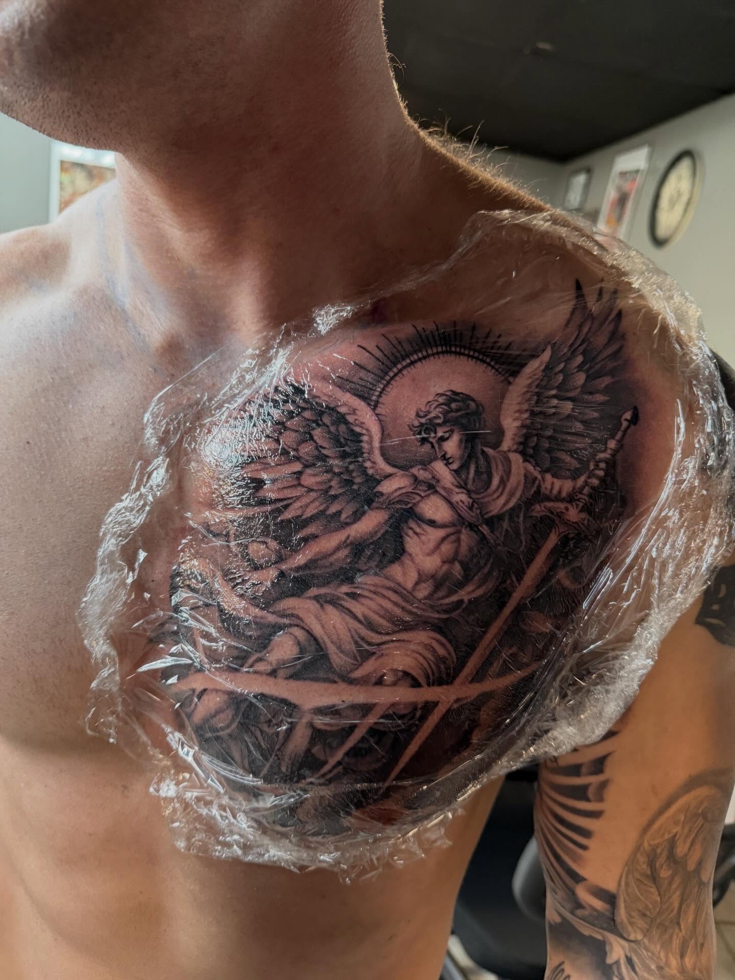 Angel black and grey tattoo on the chest by Jorge Hernandez