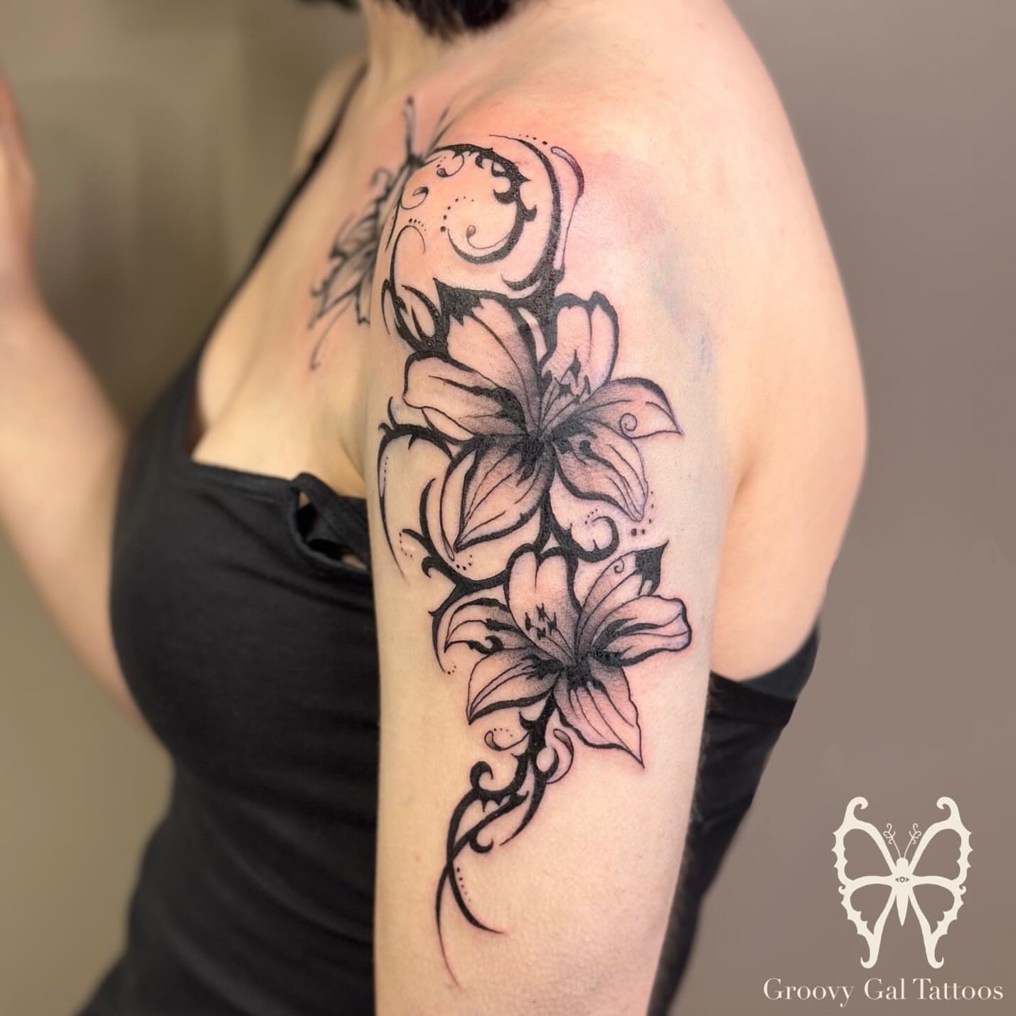 Lilies black and grey tattoo on the shoulder by Groovy P