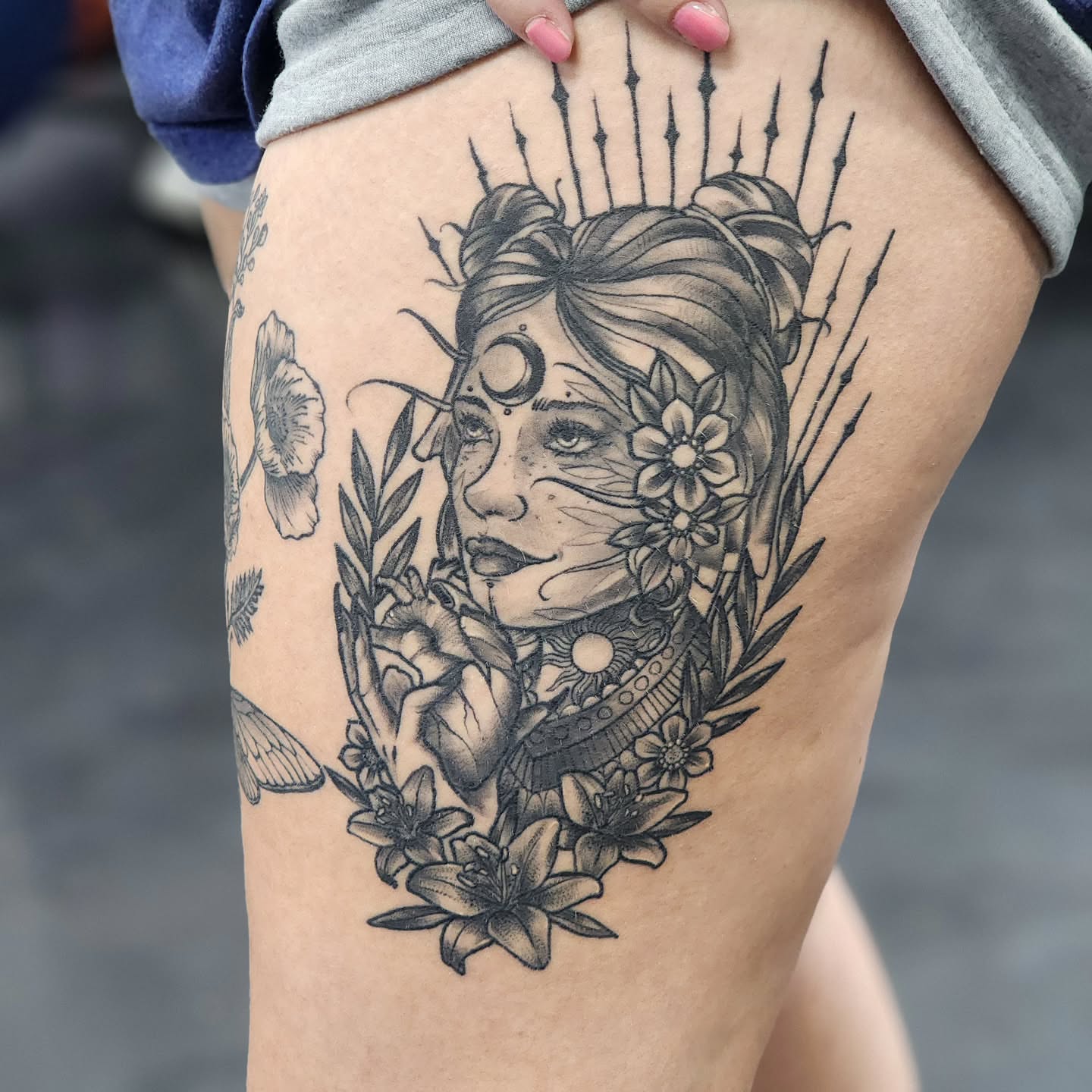 Woman with flowers realism tattoo on the thigh by Robert Glover