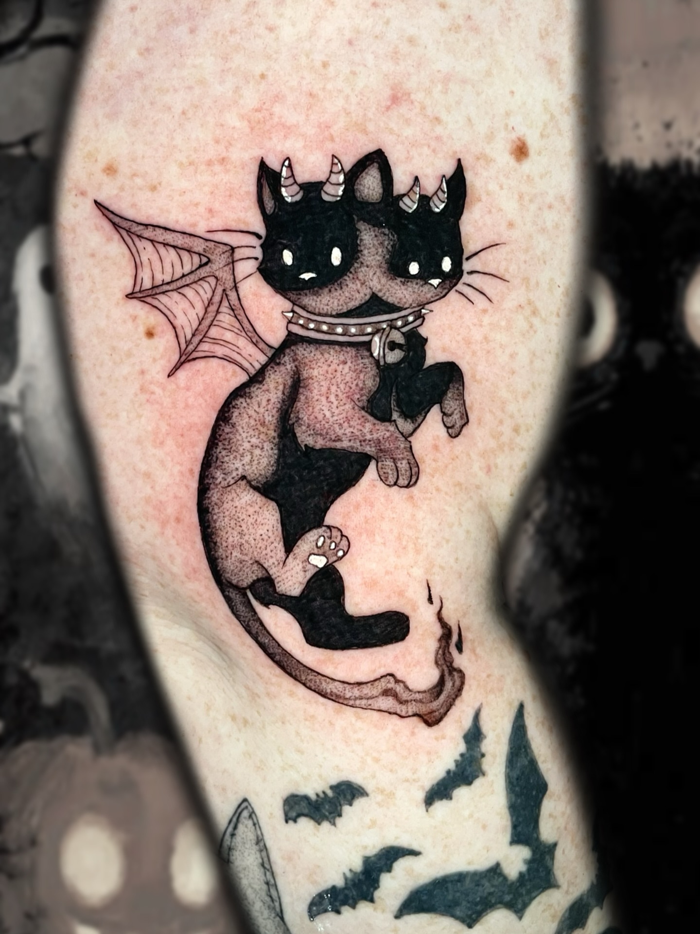 Cat demon black and grey tattoo on the forearm by Shontel Fowler