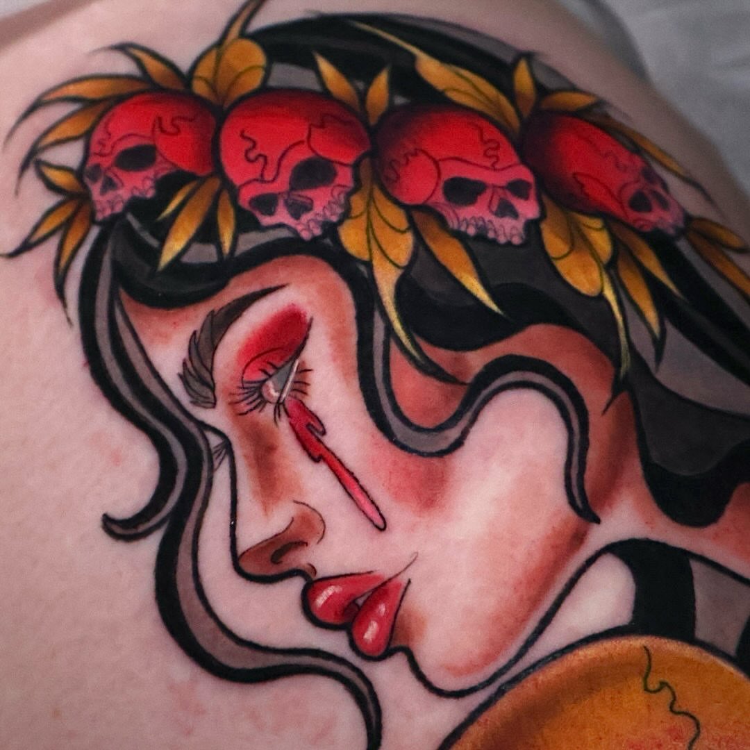 Woman with skulls American traditional tattoo on the shoulder by Bailey Drey