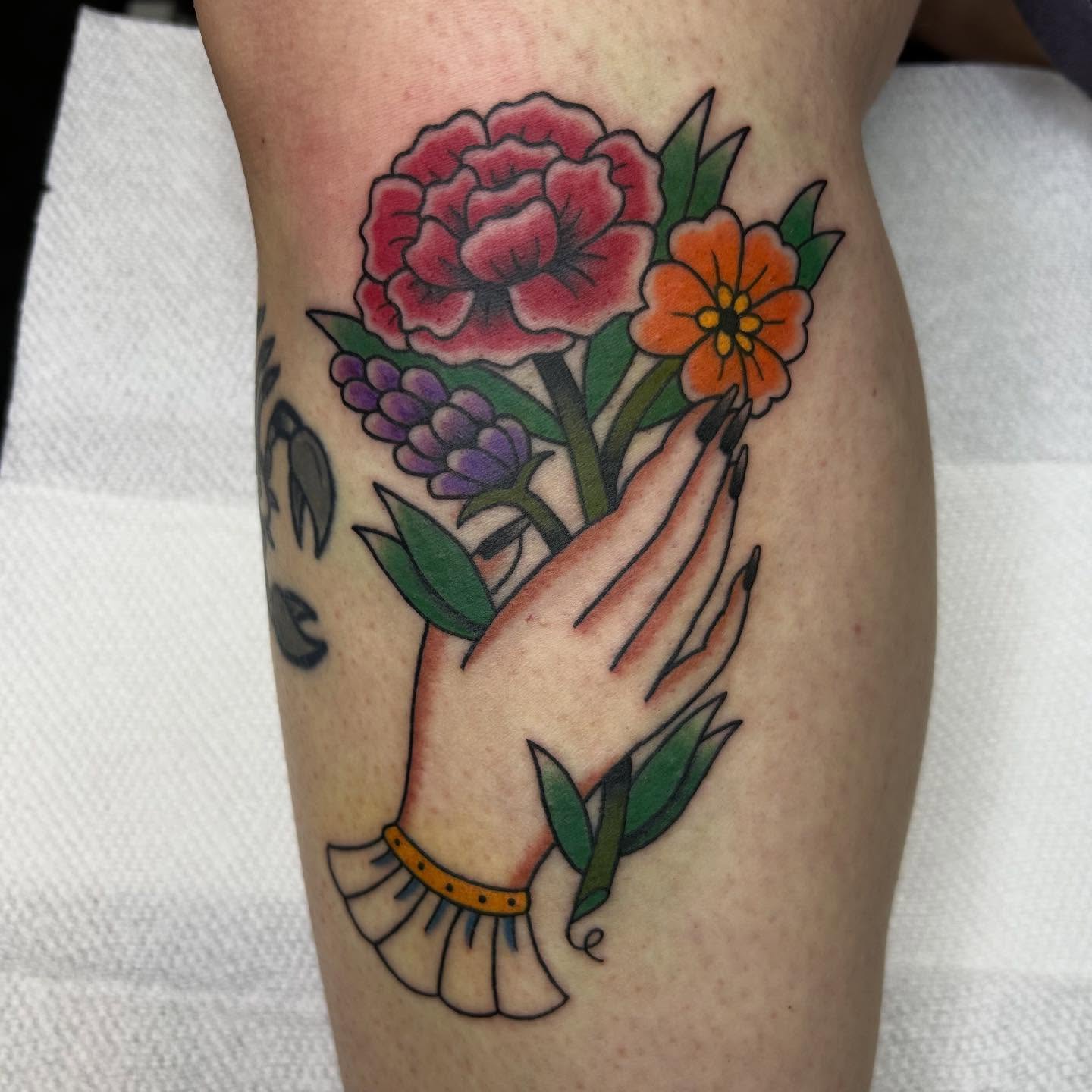 Praying hand with flowers American traditional tattoo on the forearm by Bregan ✨