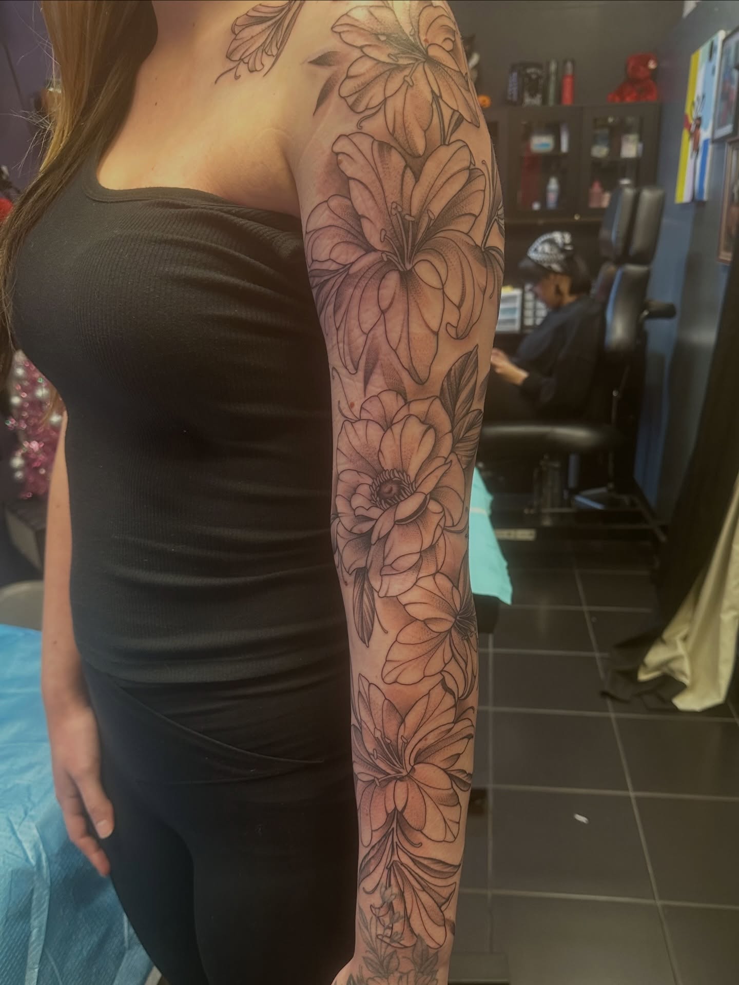 Floral arrangement black and grey tattoo on the forearm by Carly🪲 greensboro tattoo artist, Greensboro, North Carolina