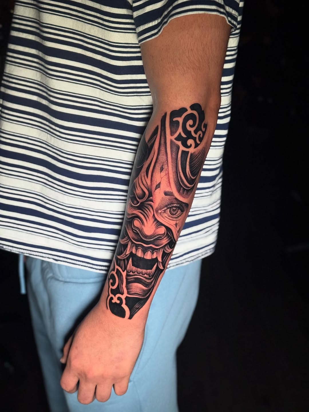 Oni mask and clouds Japanese tattoo on the forearm by Santiago M