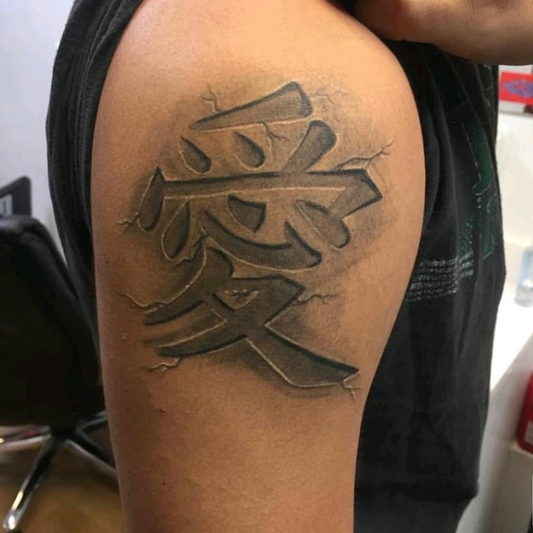 Kanji character black and grey tattoo on the shoulder by Houston Tattoo Artist