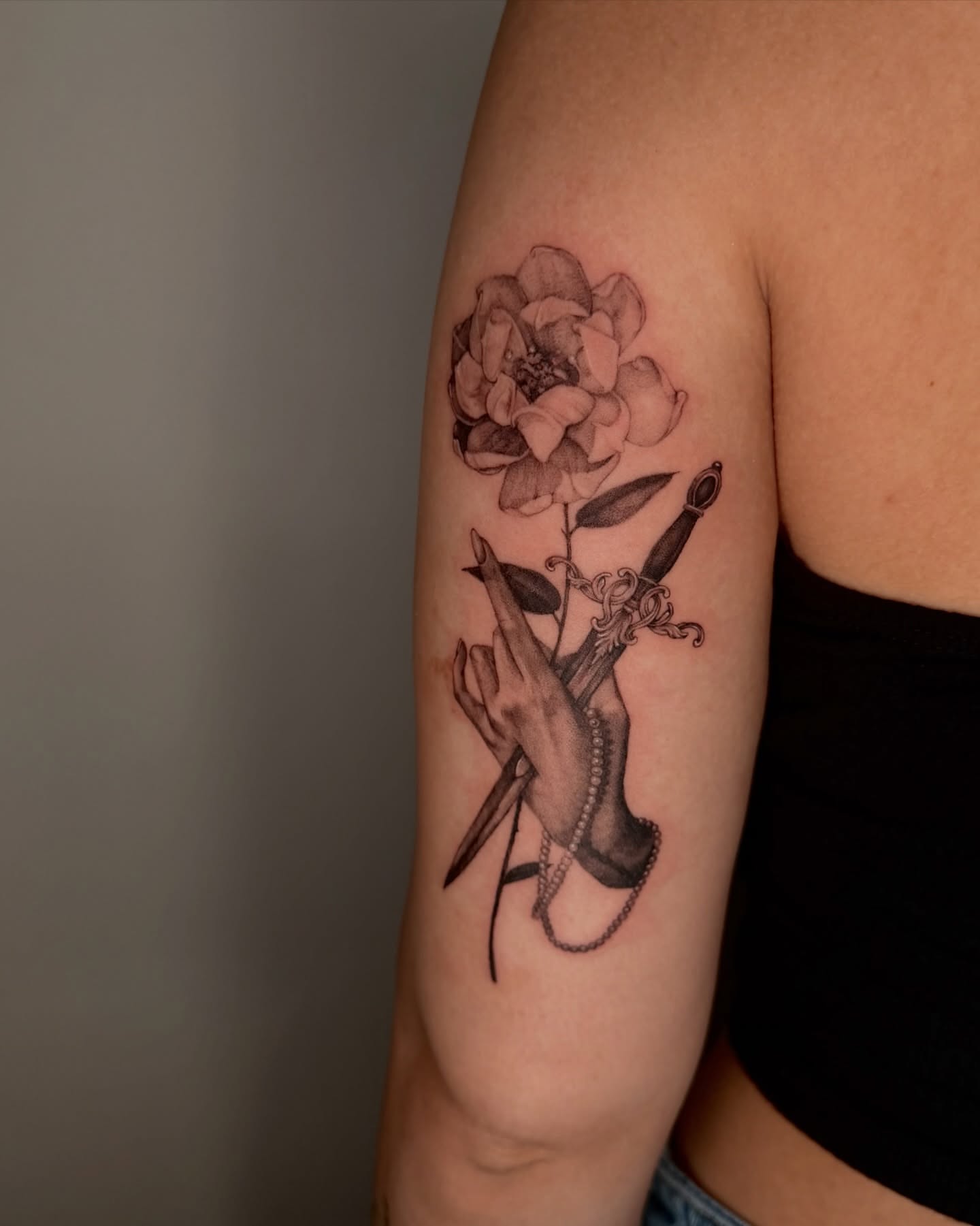 Flower and hand realism tattoo on the forearm by Sab