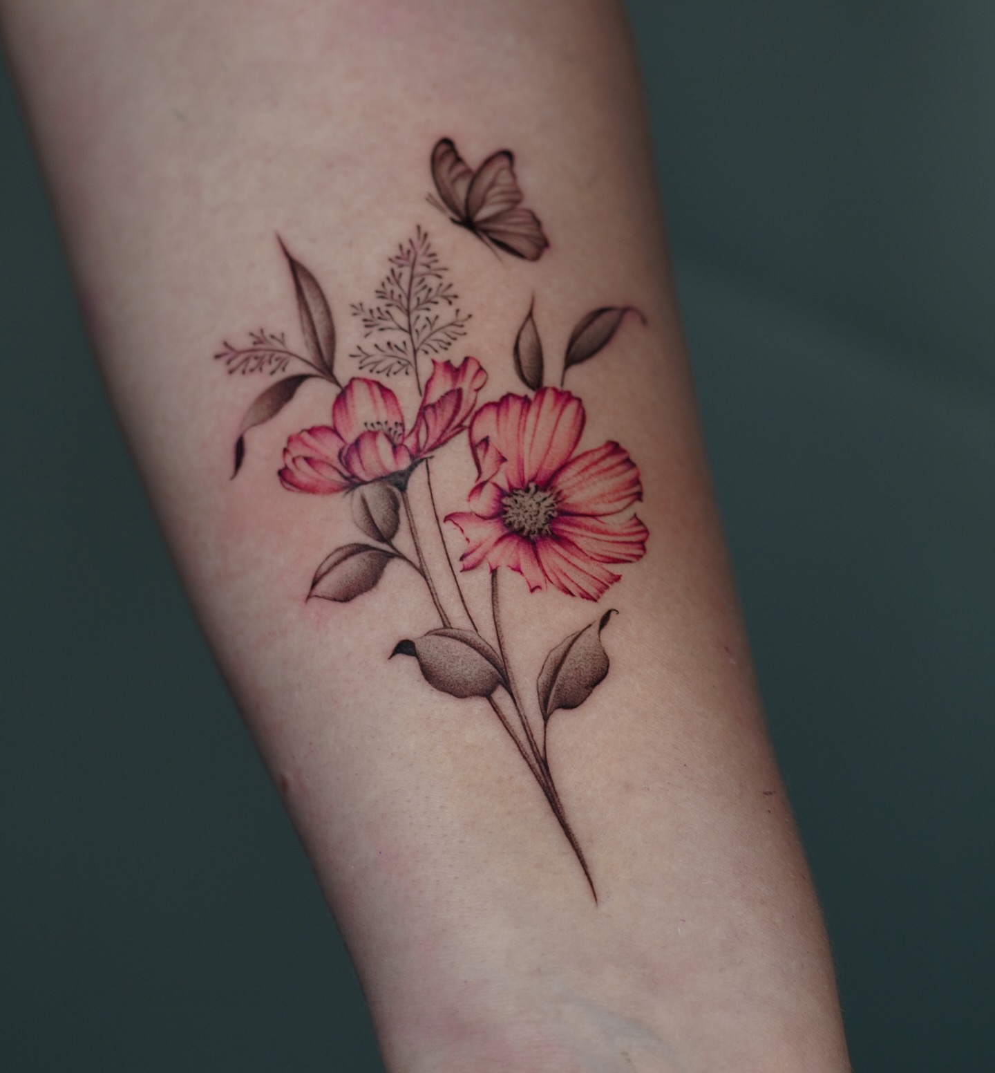 Flowers and butterfly realism tattoo on the forearm by Sophia Delfino