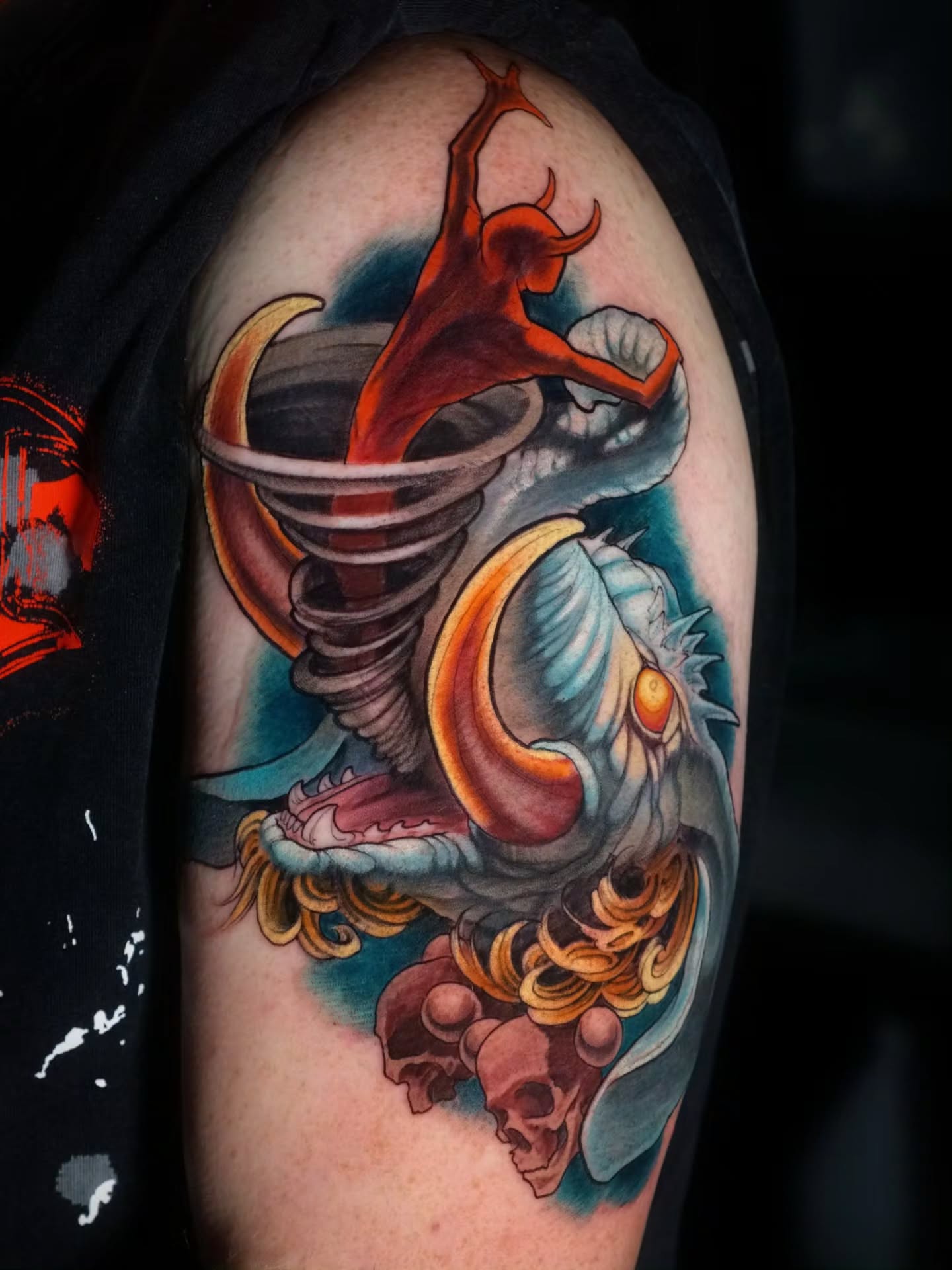 Demon and fish American traditional tattoo on the upper arm by Justin Byrd, Kansas City, Missouri