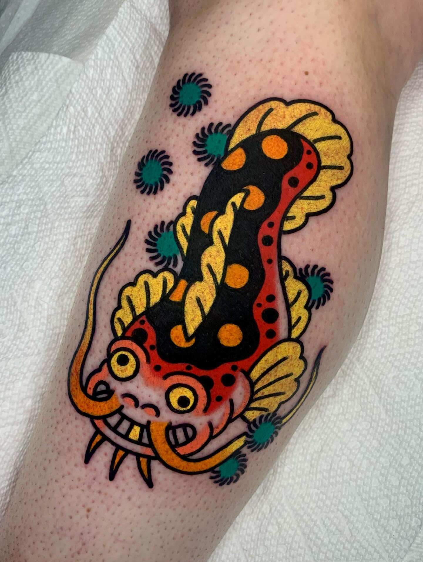 Koi fish American traditional tattoo on the forearm by Shawn VanKirk