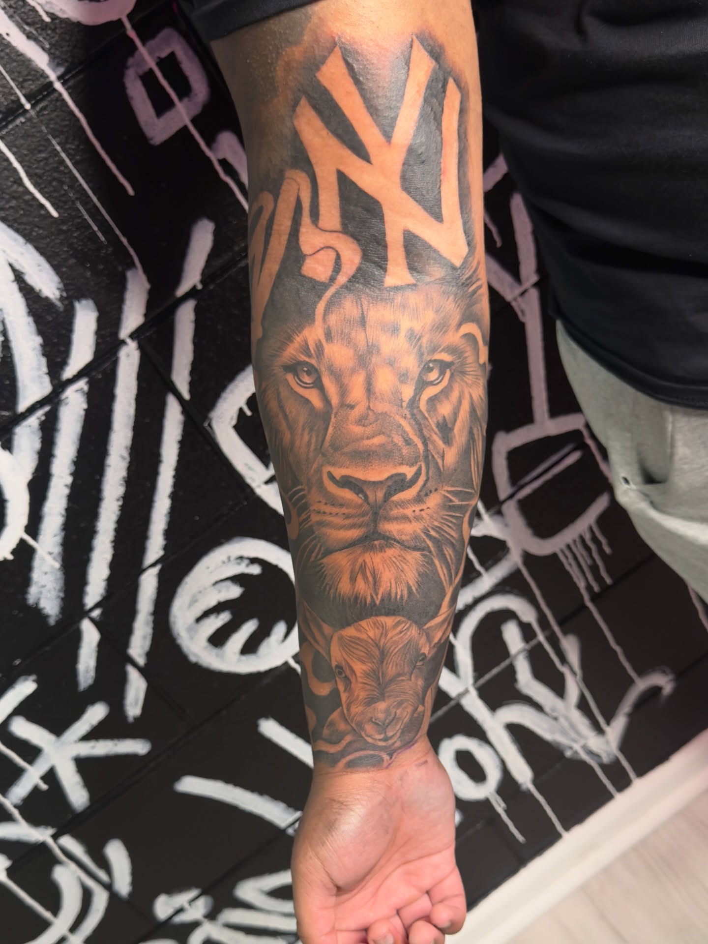 Lion realism tattoo on the forearm by Savannah Tattoo Artist