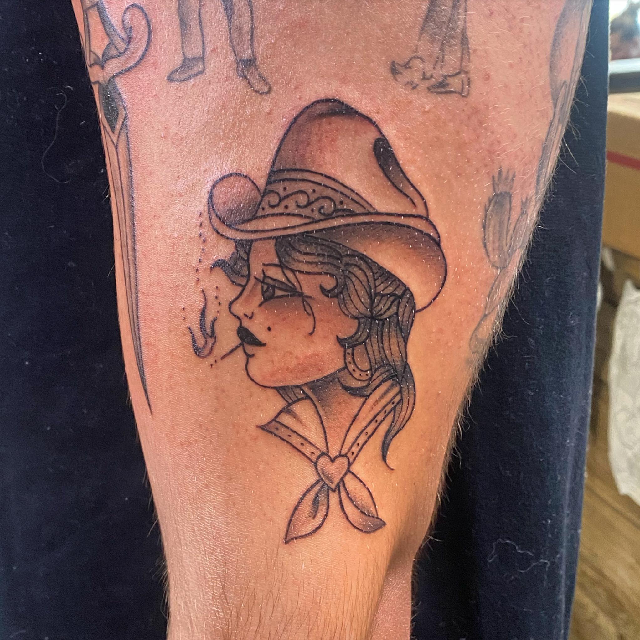Woman wearing hat American traditional tattoo on the forearm by Spencer Jones Tattoos