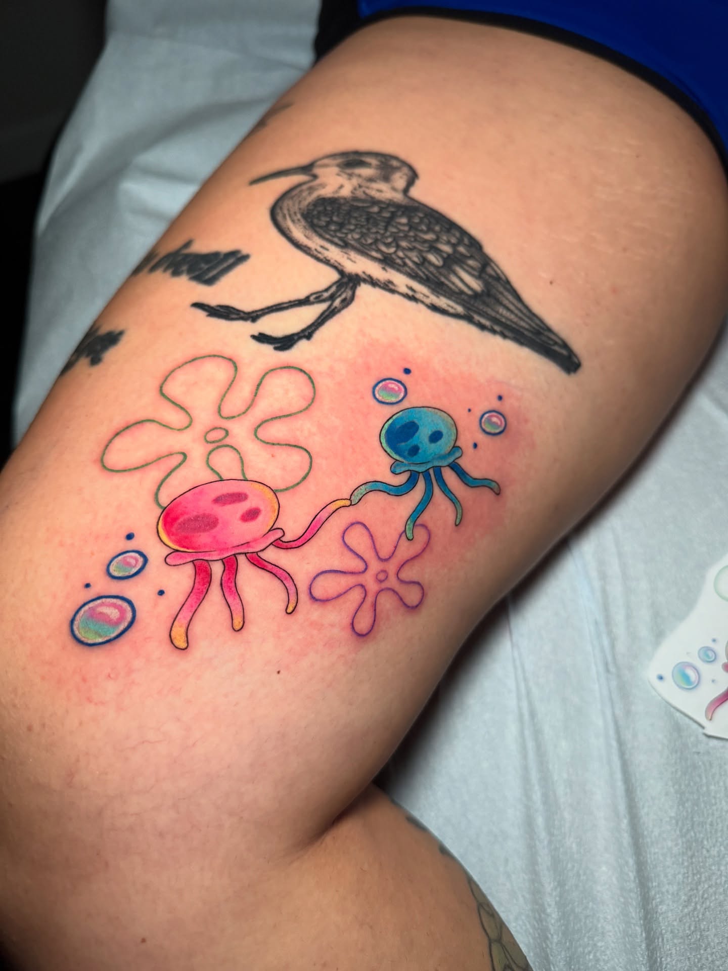 Bird and jellyfish new school tattoo on the thigh by 𝕹𝖆𝖙
