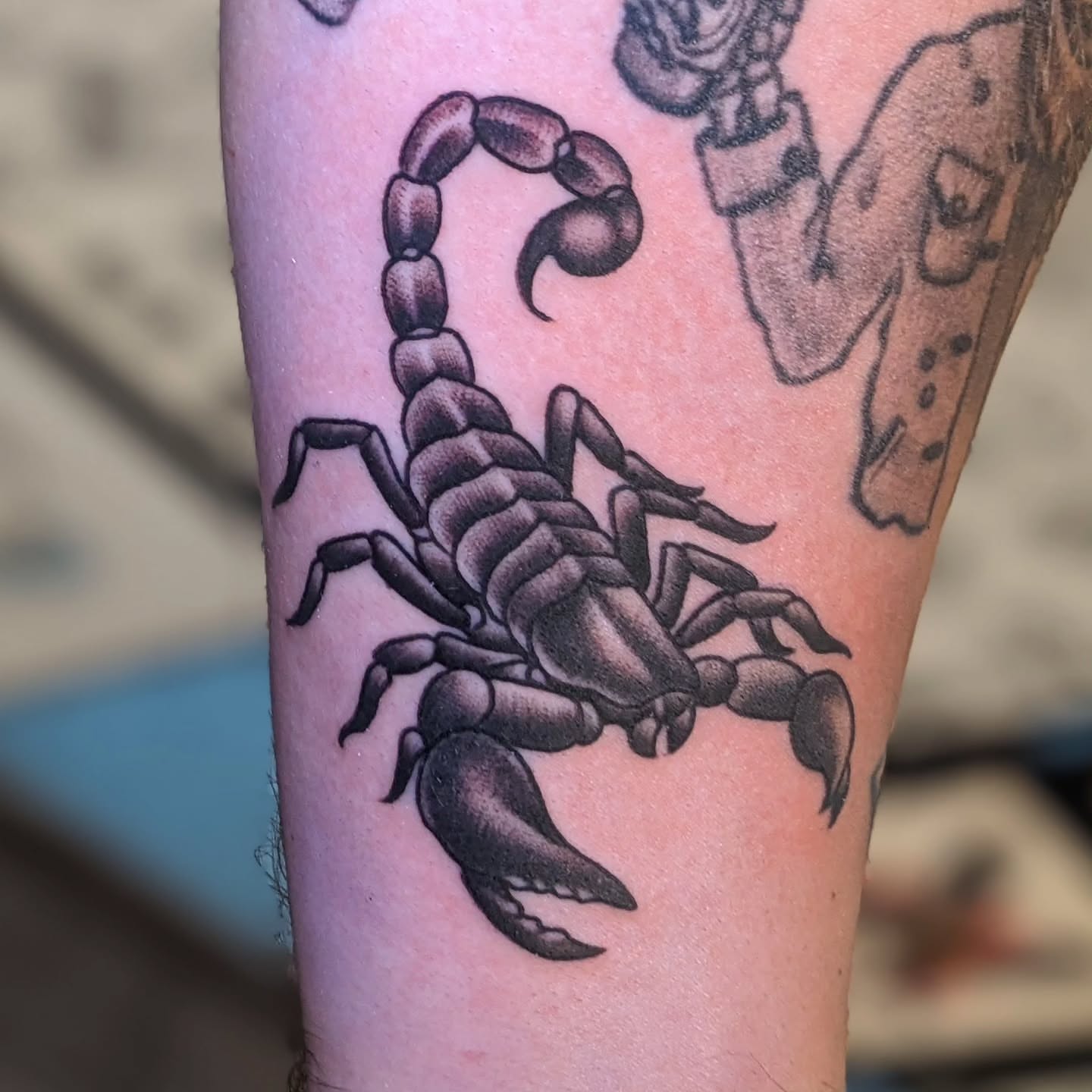 Scorpion black and grey tattoo on the forearm by Matt Simmonds