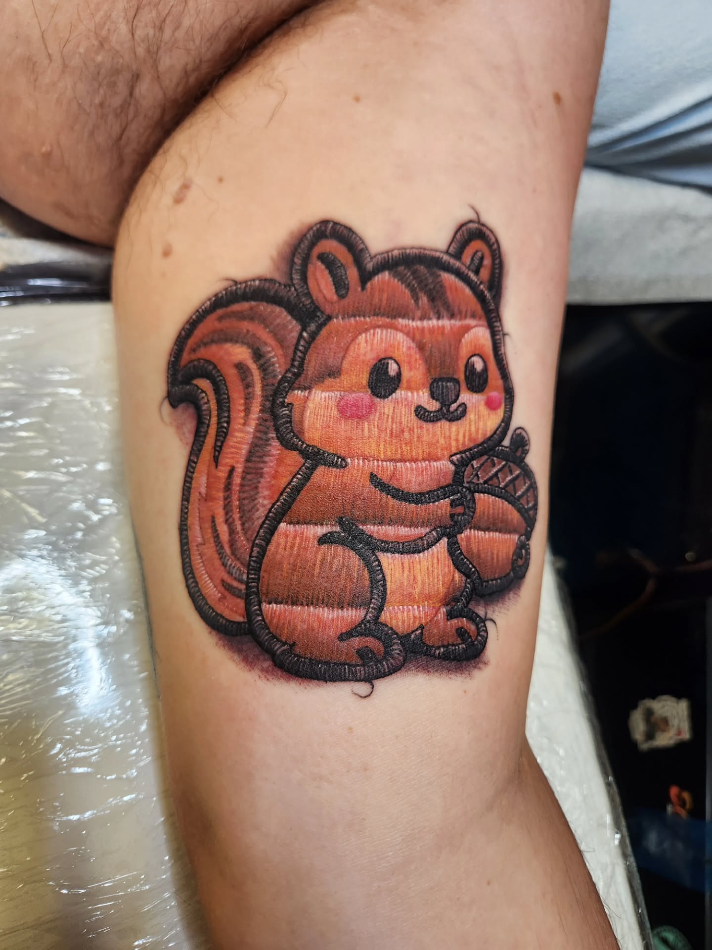 Squirrel dotwork tattoo on the thigh by Chris Bowen