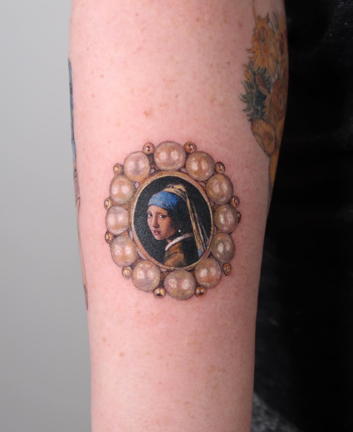 Girl with a pearl earring realism tattoo on the forearm by Alissa Jung