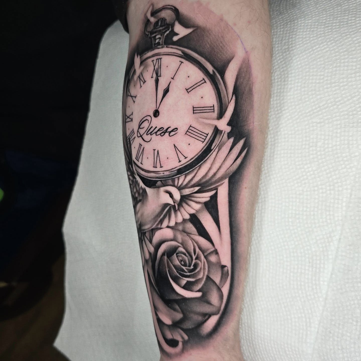 Clock and dove realism tattoo on the forearm by Justin Eldridge