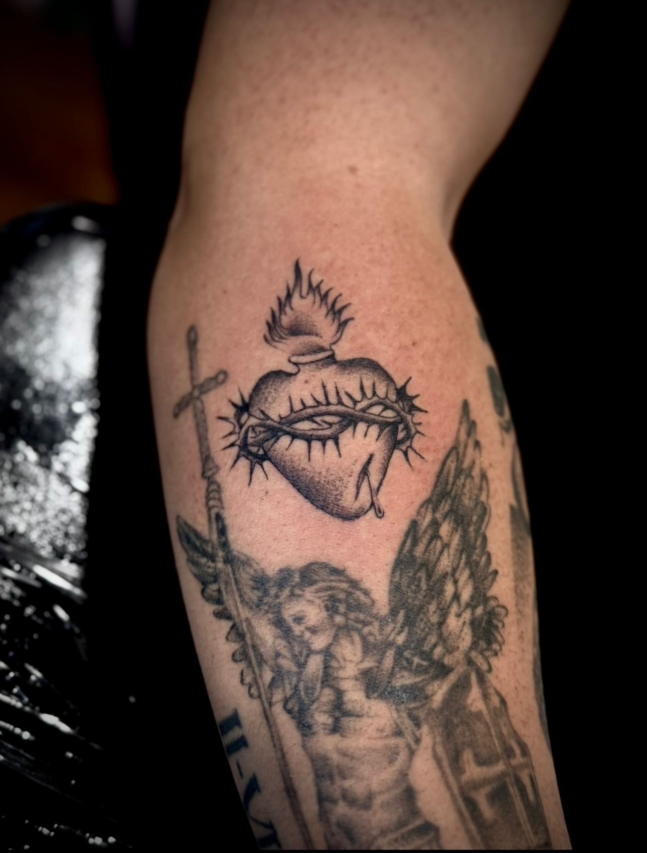 Sacred heart with angel realism tattoo on the forearm by Thomas Martinez