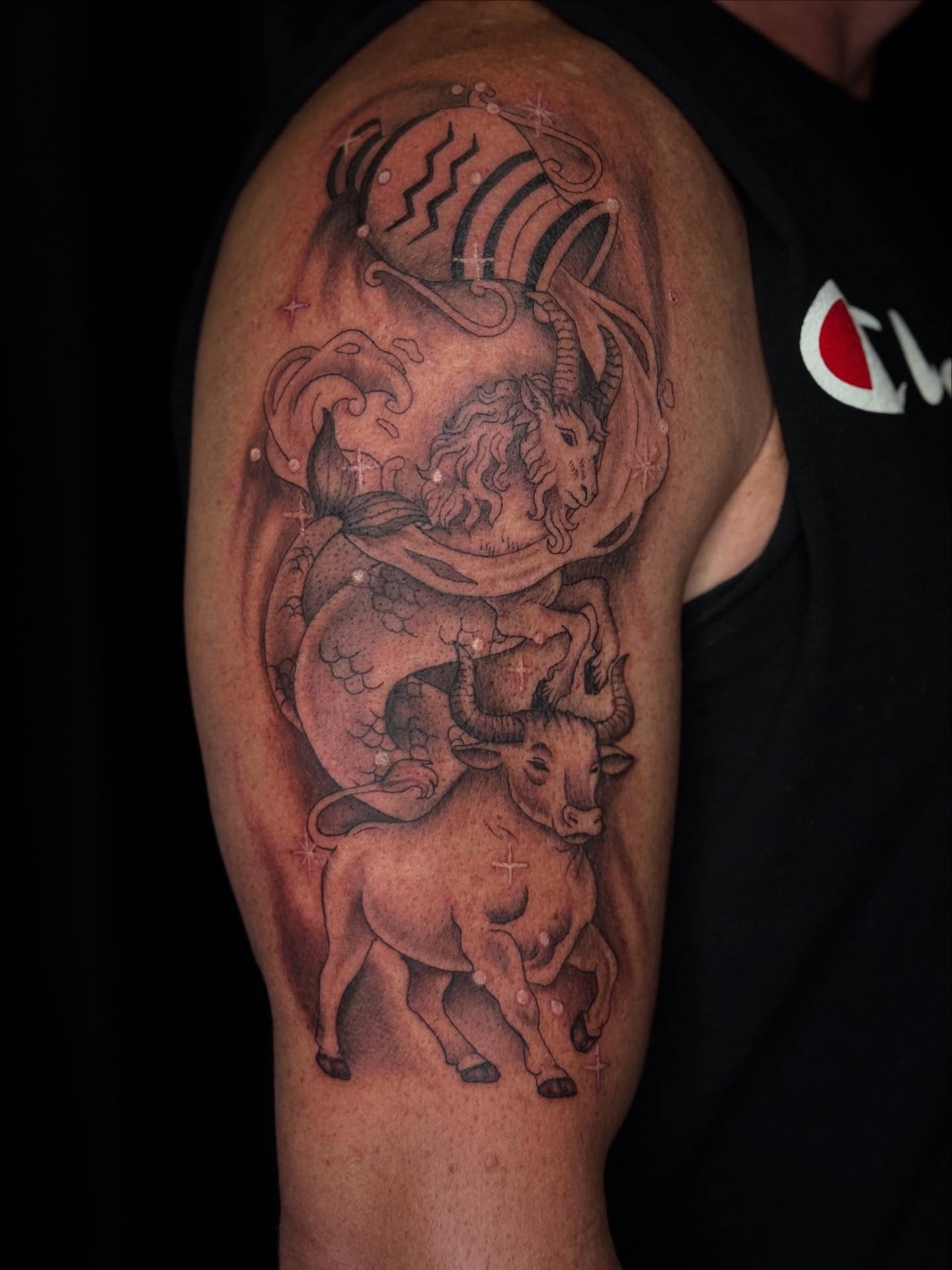 Bull and dragon black and grey tattoo on the upper arm by Ashley Hsiung *Panda*