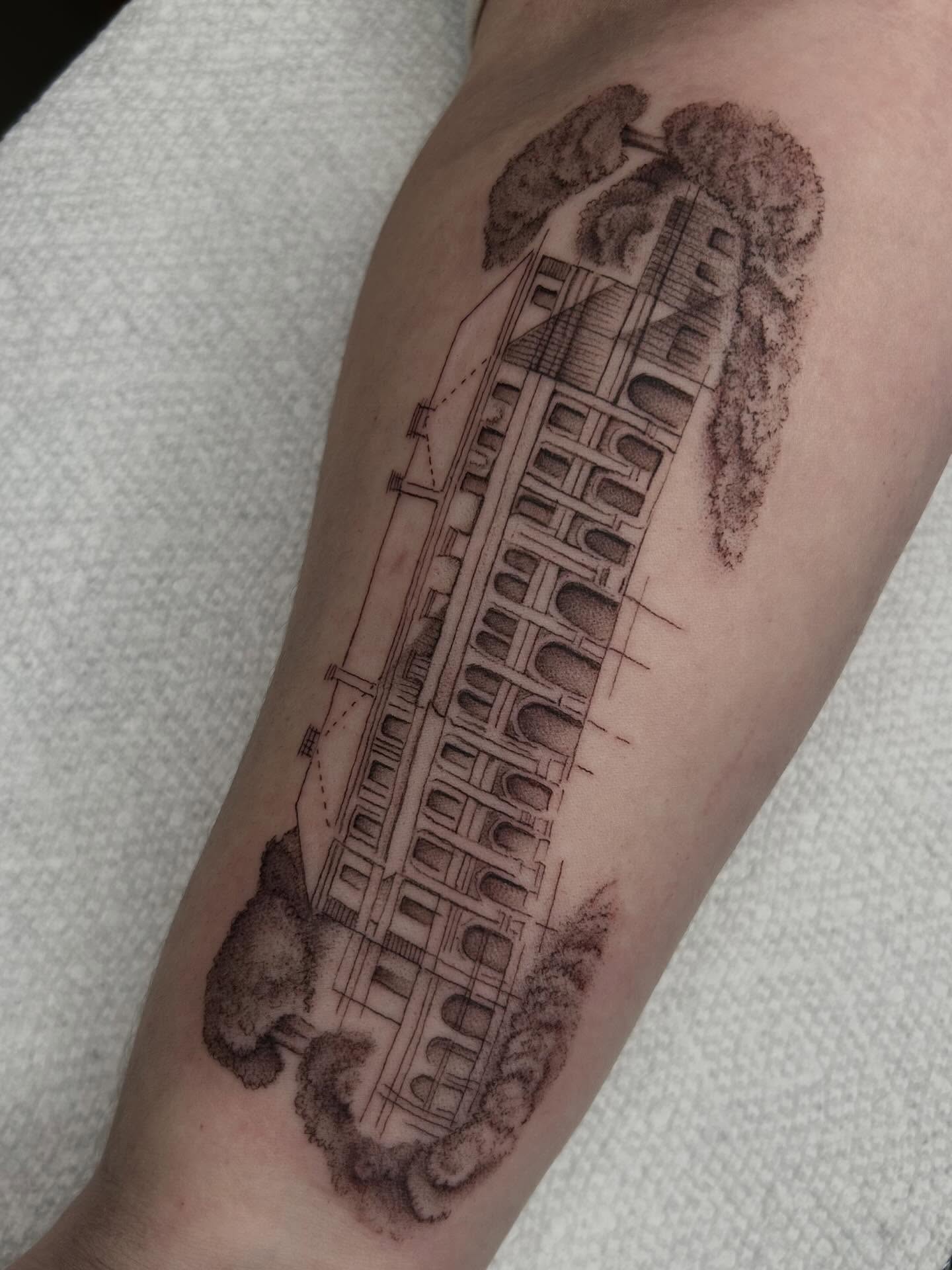 Building black and grey tattoo on the forearm by Olivia Fox