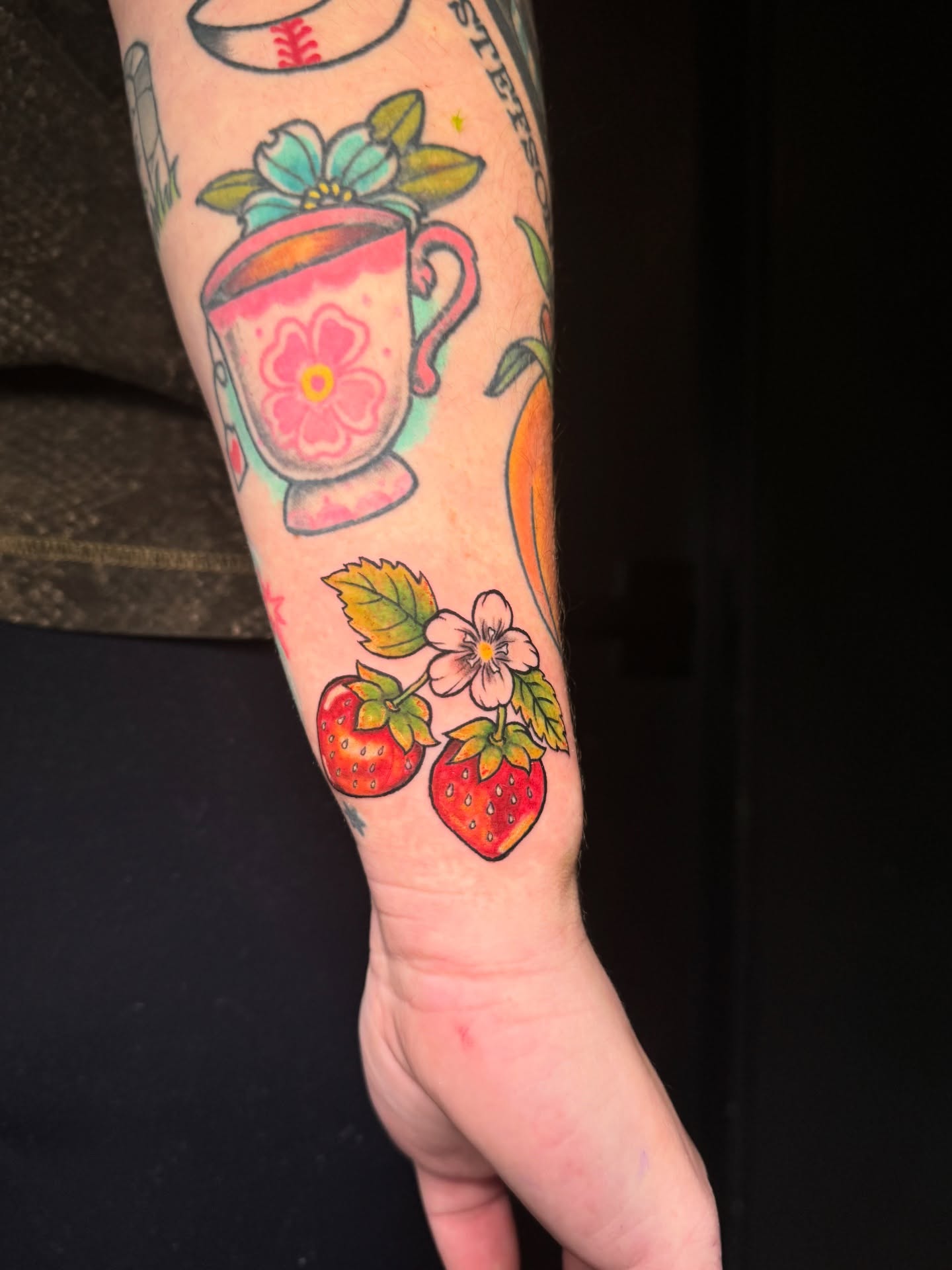 Strawberries and flowers new school tattoo on the forearm by Jewels, St. George, Utah