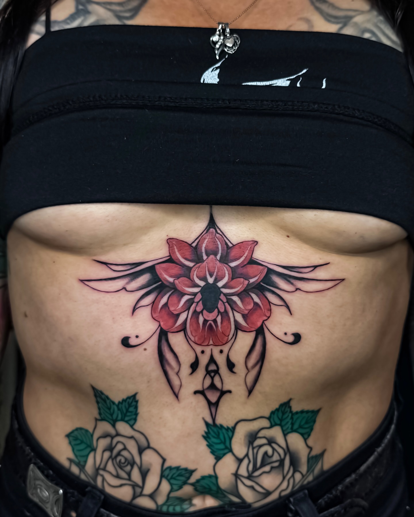 Lotus flower neo-traditional tattoo on the torso by Amelia
