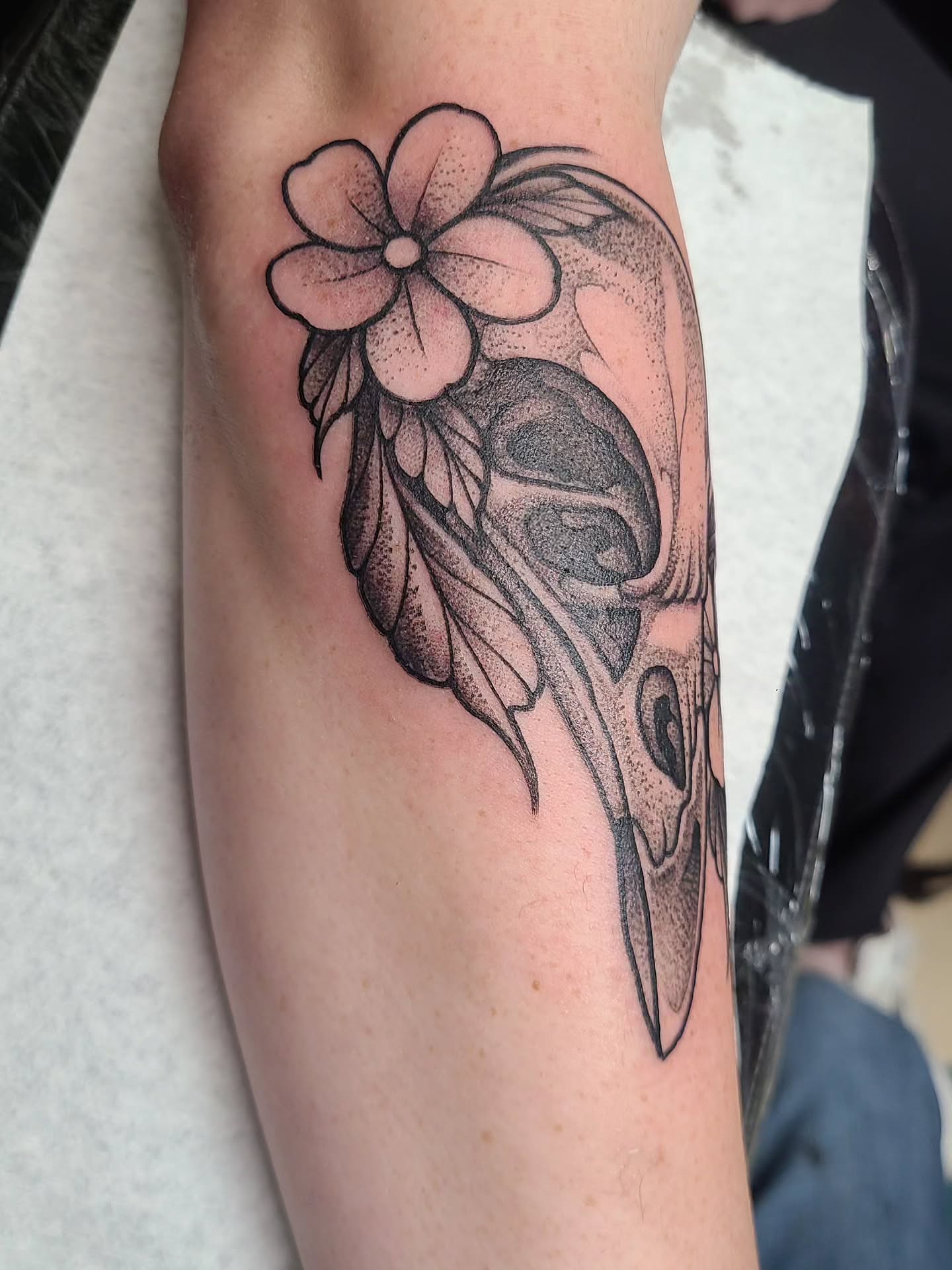 Flower and skull dotwork tattoo on the forearm by David Vodicka