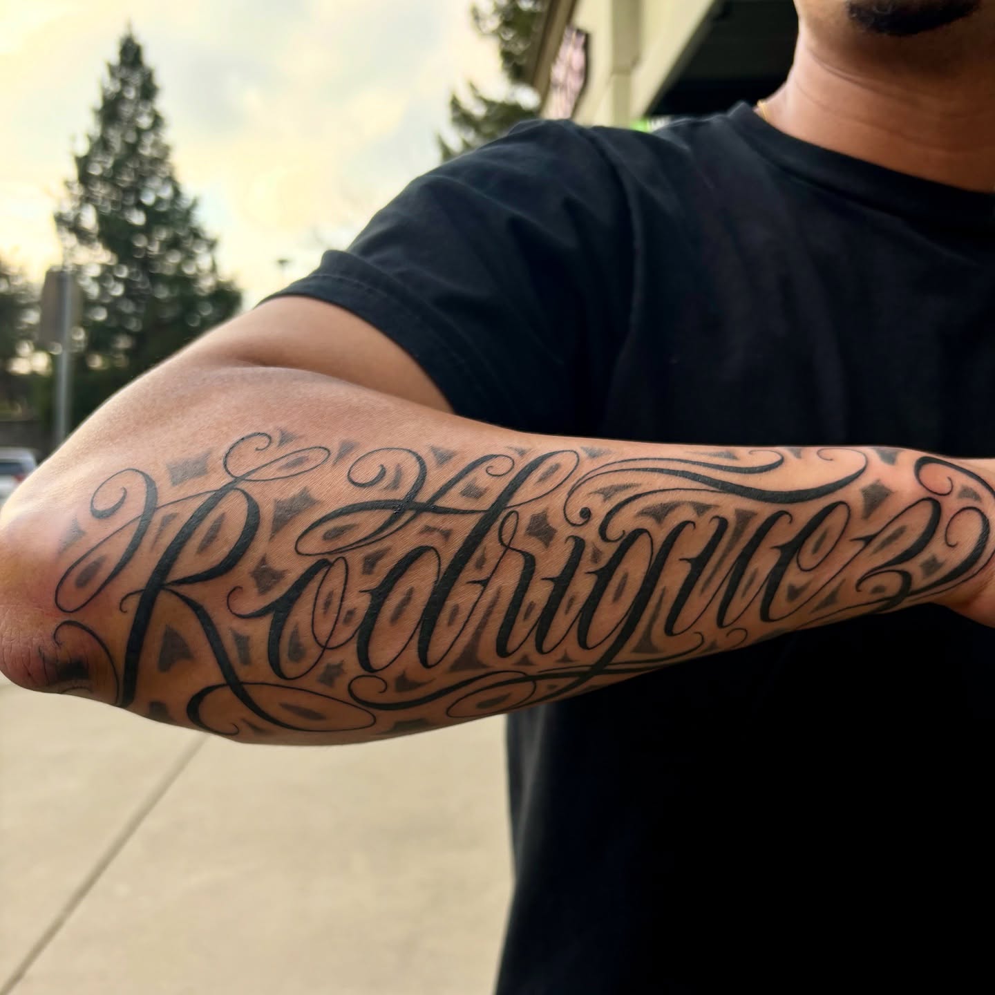 Rodriguez lettering script tattoo on the forearm by Cristiano Ochoa, Elk Grove, California