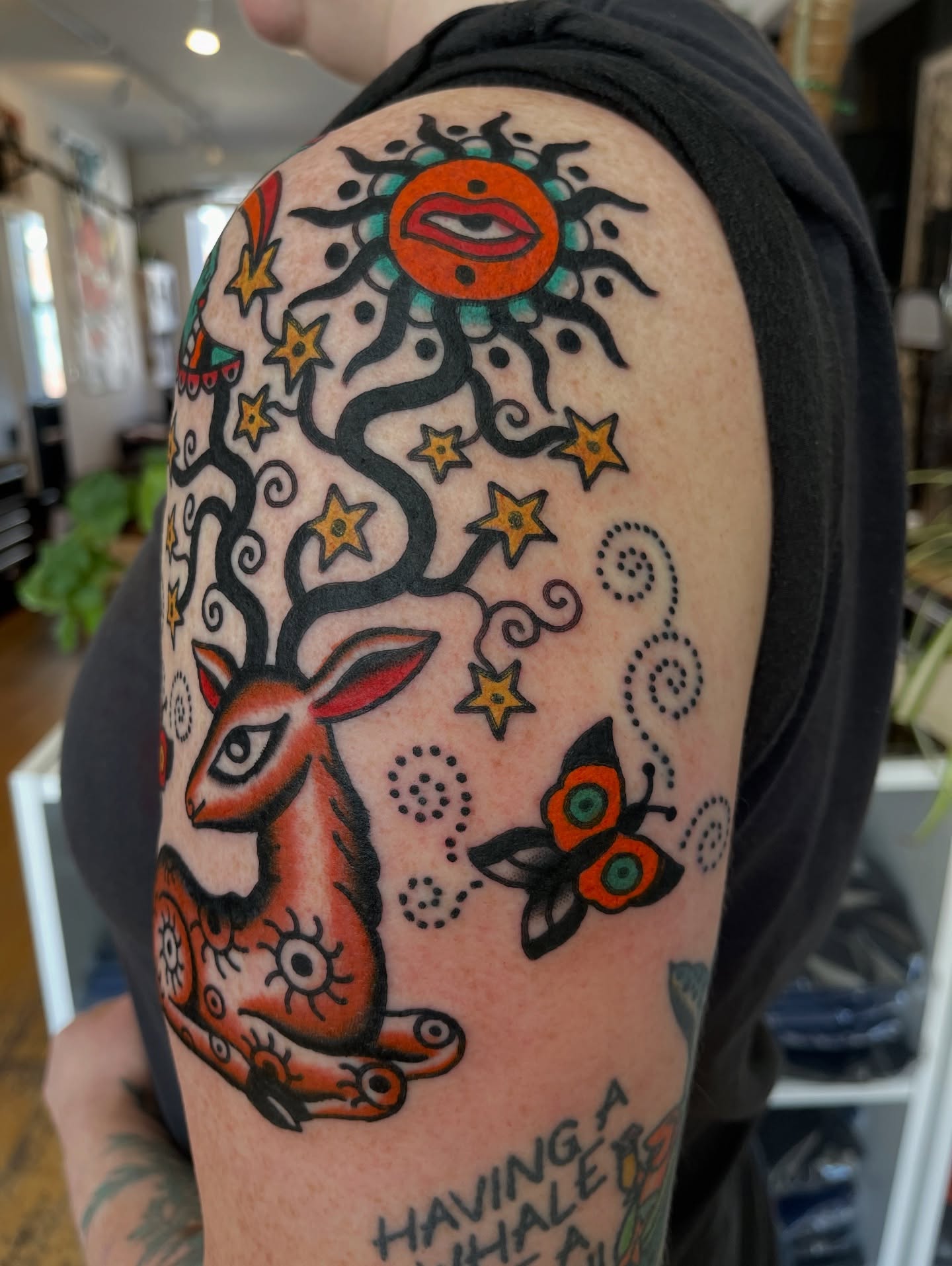 Deer and sun American traditional tattoo on the shoulder by Swasthik Iyengar, New York, New York