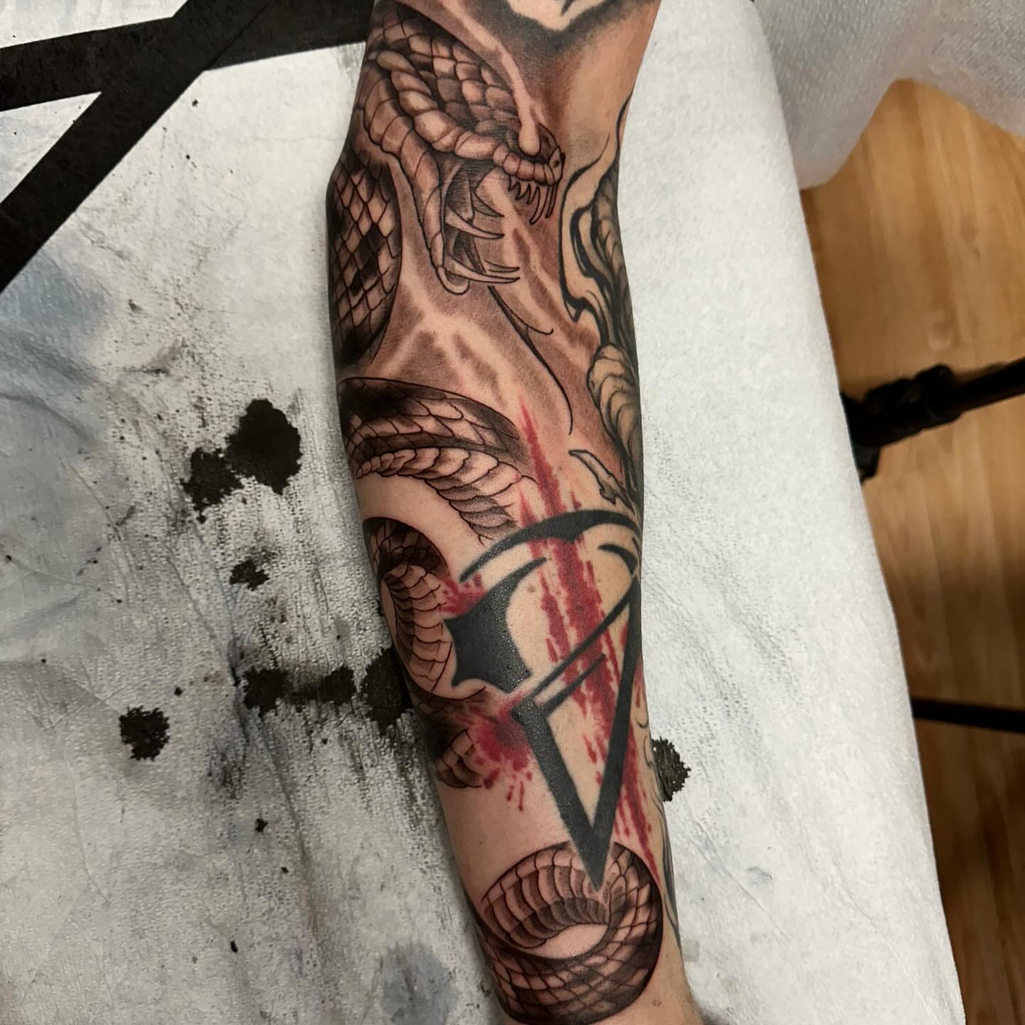 Snake and dagger realism tattoo on the forearm by Sebastian Livingston