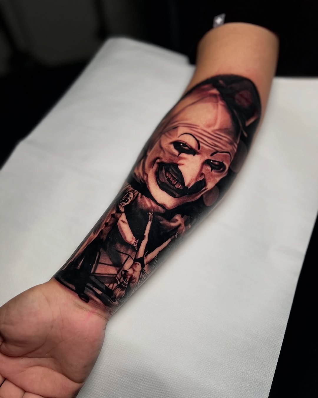 Art the Clown from Terrifier realism tattoo on the forearm by James Foltz