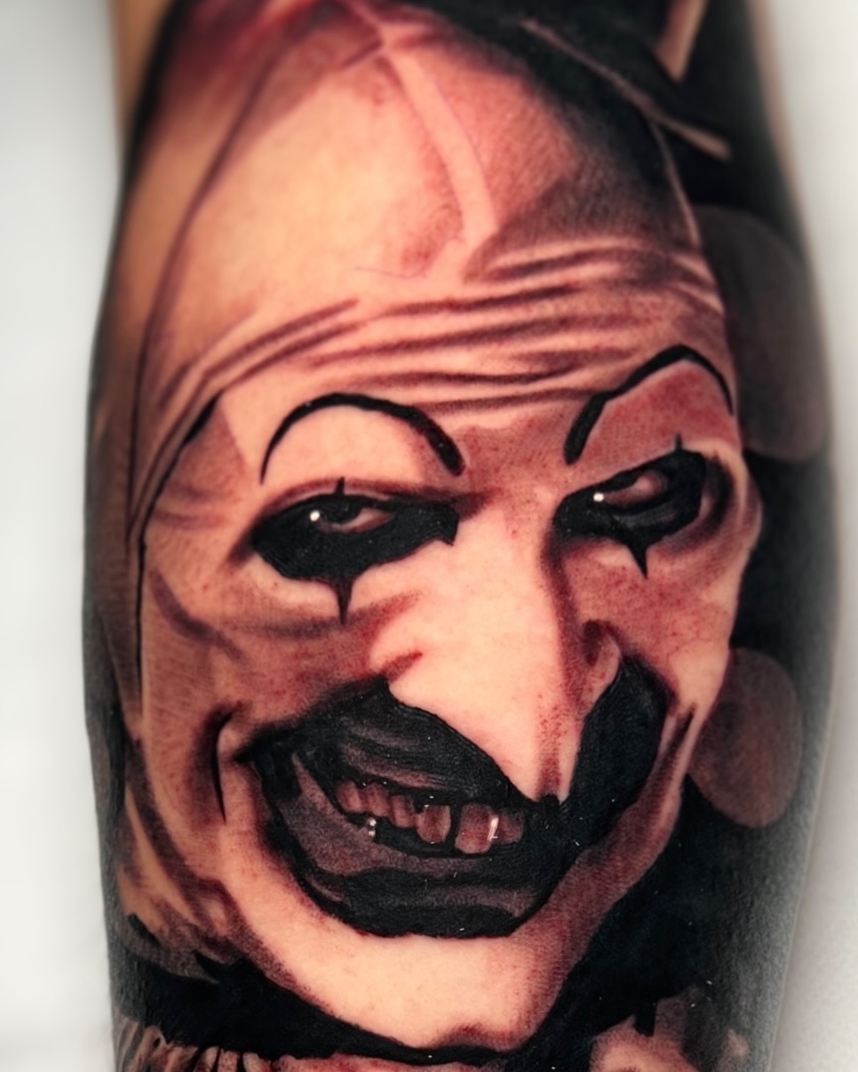 Creepy clown portrait realism tattoo on the forearm by James Foltz