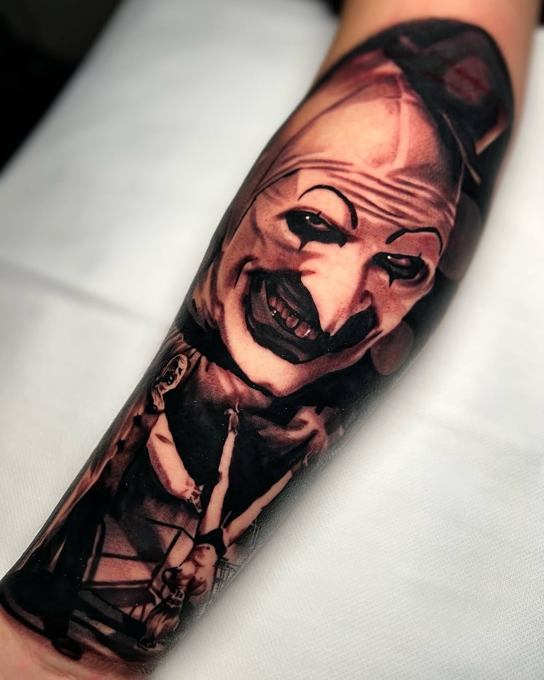 Art the Clown from Terrifier realism tattoo on the forearm by James Foltz