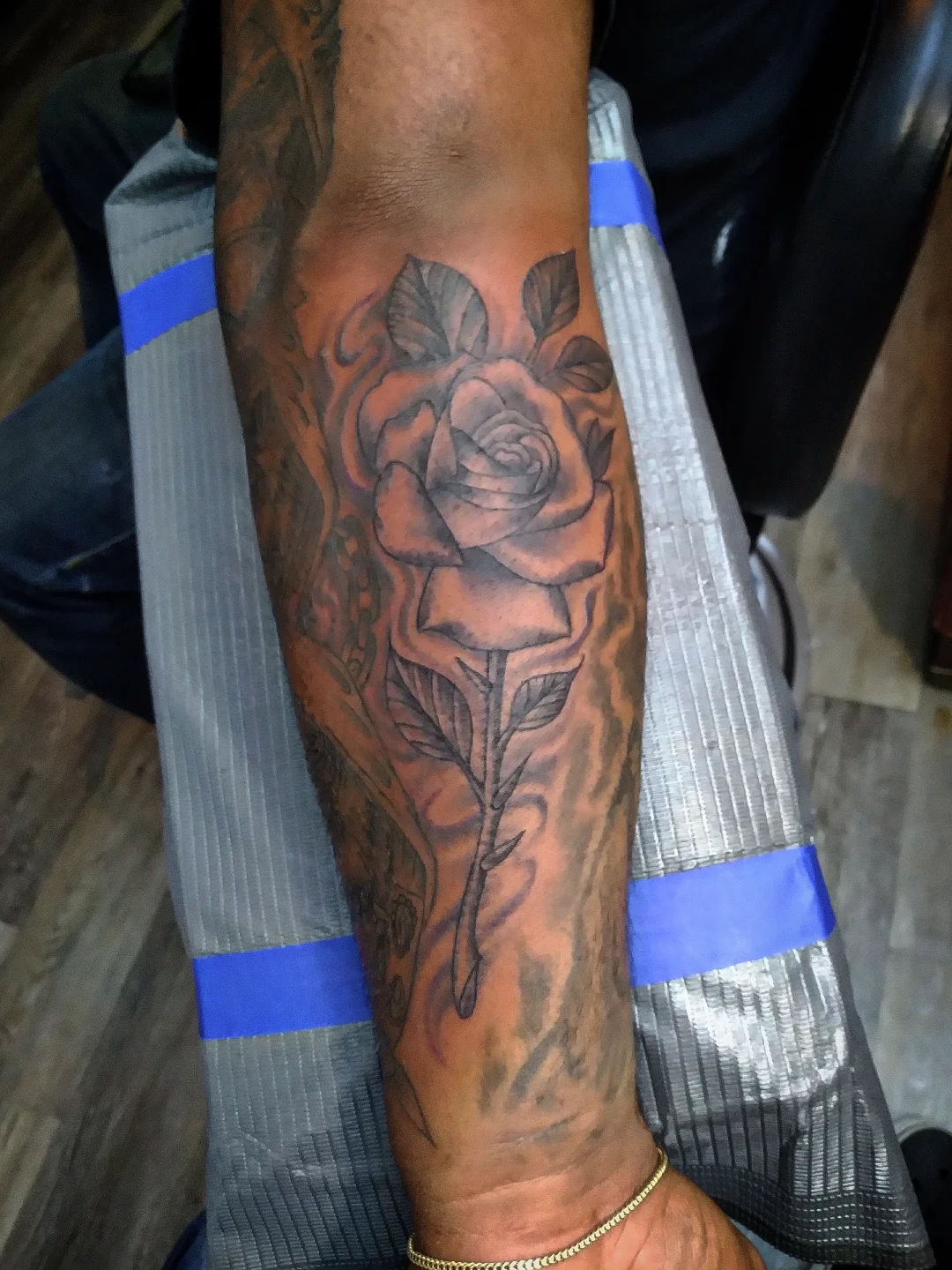 Rose black and grey tattoo on the forearm by Josh Sroga