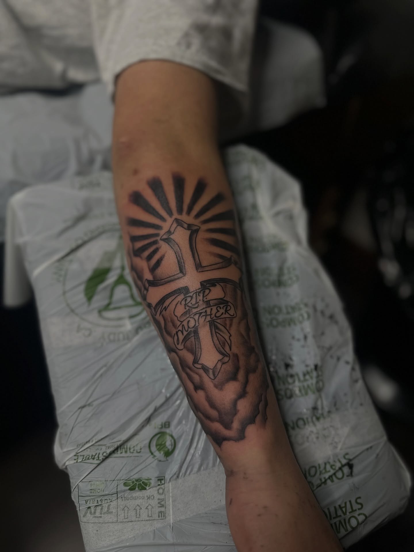 Cross with sunburst black and grey tattoo on the forearm by แดแด ๐ฎ๐ท ๐ฆ๐ซ