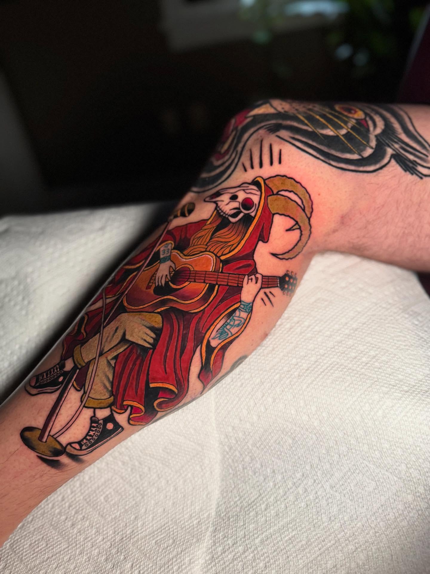 Musician playing guitar American traditional tattoo on the forearm by Dylan Walker