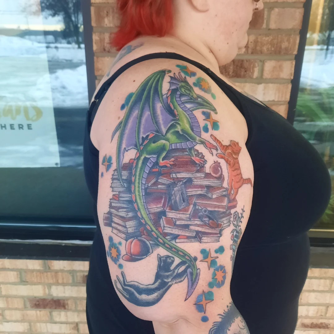 Dragon and books dotwork tattoo on the shoulder by Kaetlyn