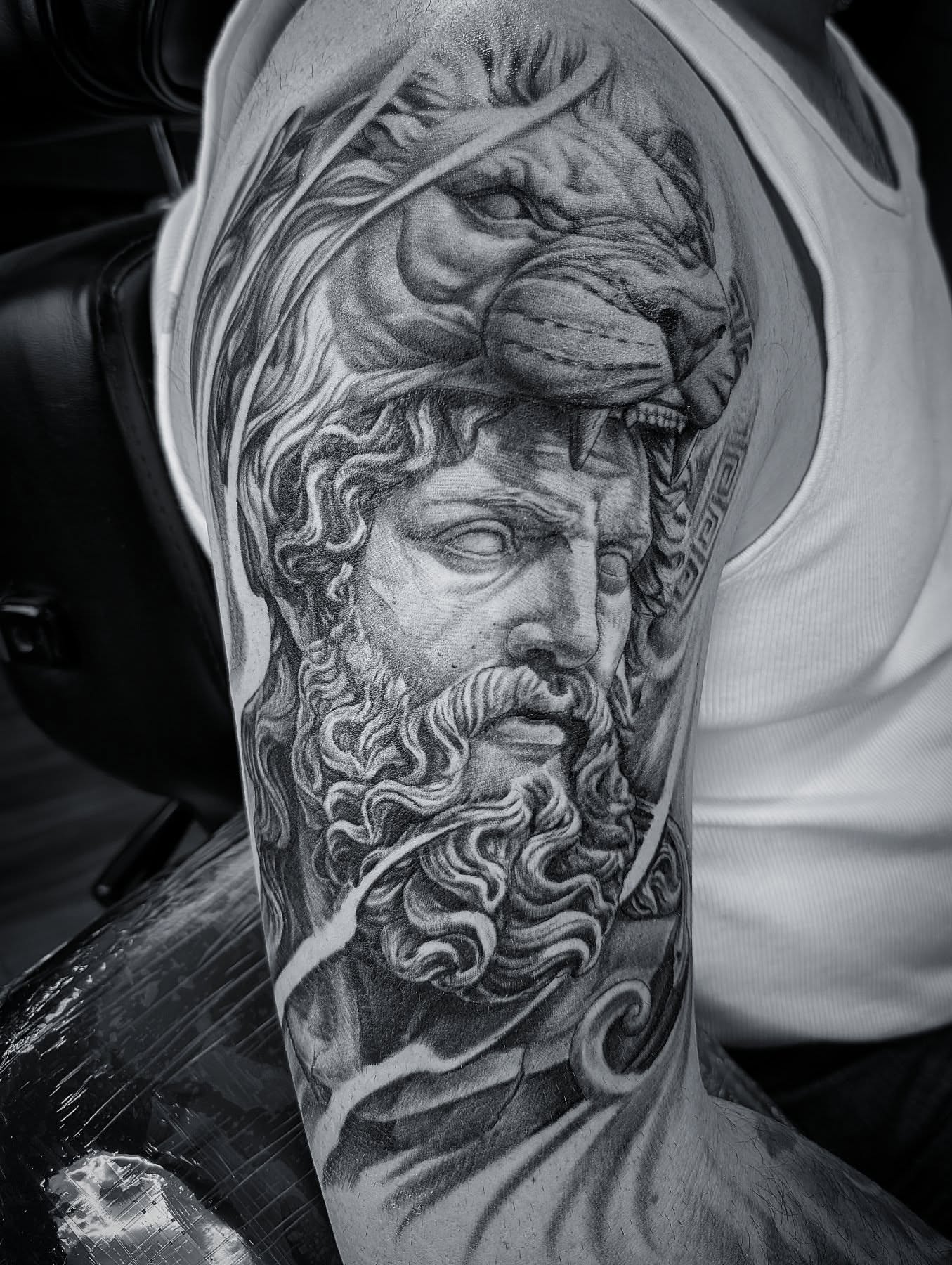 God-like figure realism tattoo on the upper arm by Will Alexander, Lombard, Illinois
